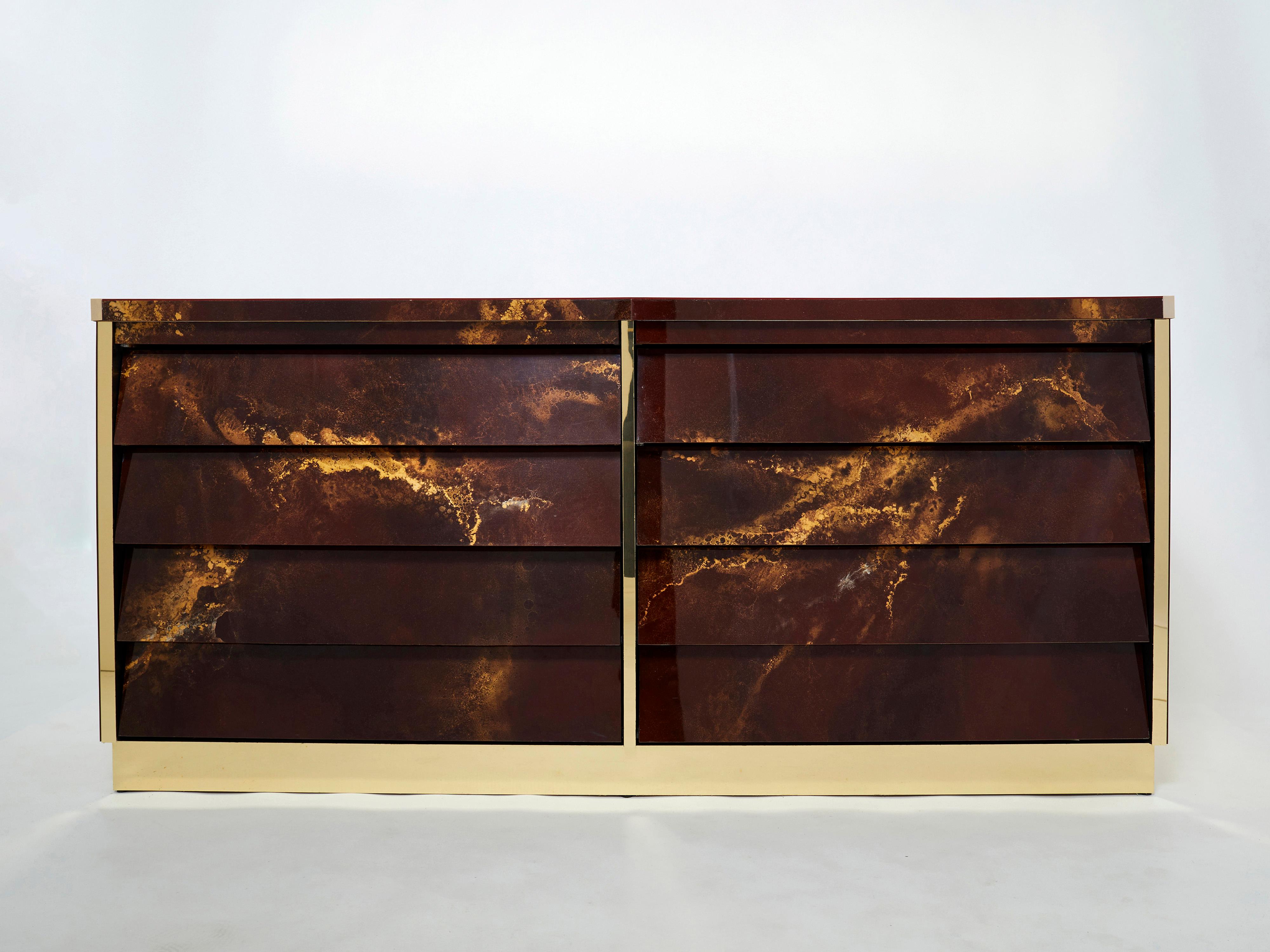 An exciting example of French design firm Maison Jansen’s commissioned pieces. This large sideboard is made from solid oak, lacquered in a rich dark brown and bronze–golden finish. The resulting effect is a beautiful mottling of color around the