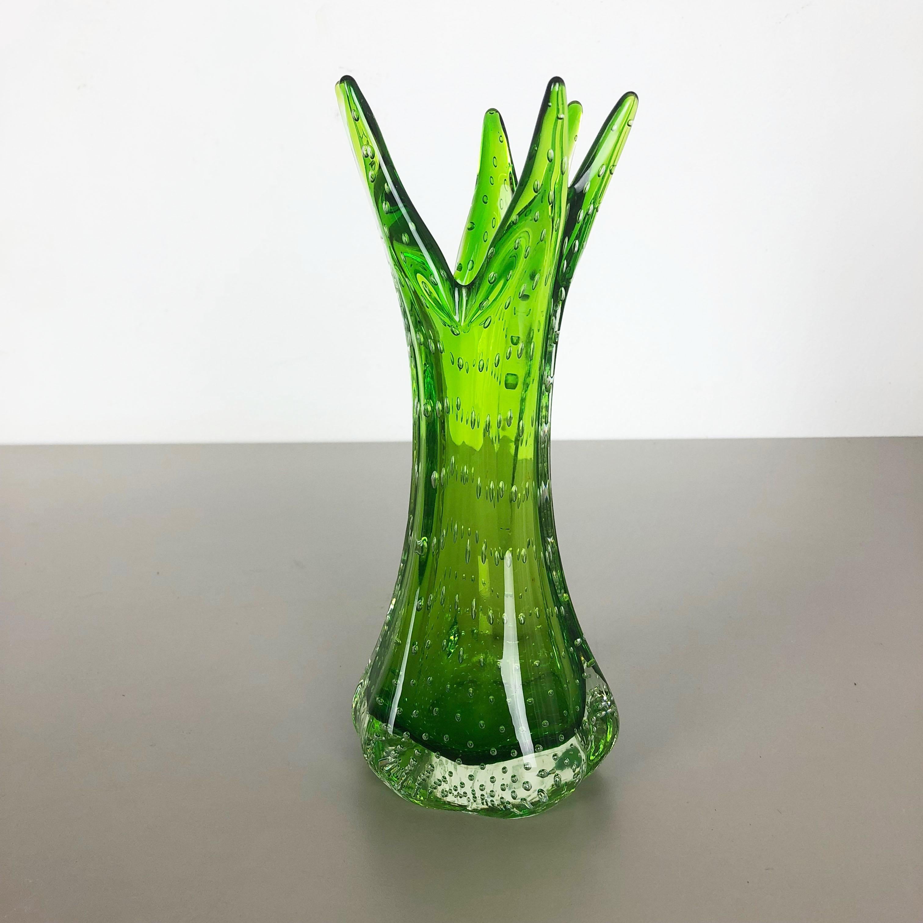 Article:

Murano glass vase element

Origin:

Murano, Italy


Decade:

1970s


This original glass vase was produced in the 1970s in Murano, Italy. An elegant green Murano glass vase utilizing the bullicante technique of controlled