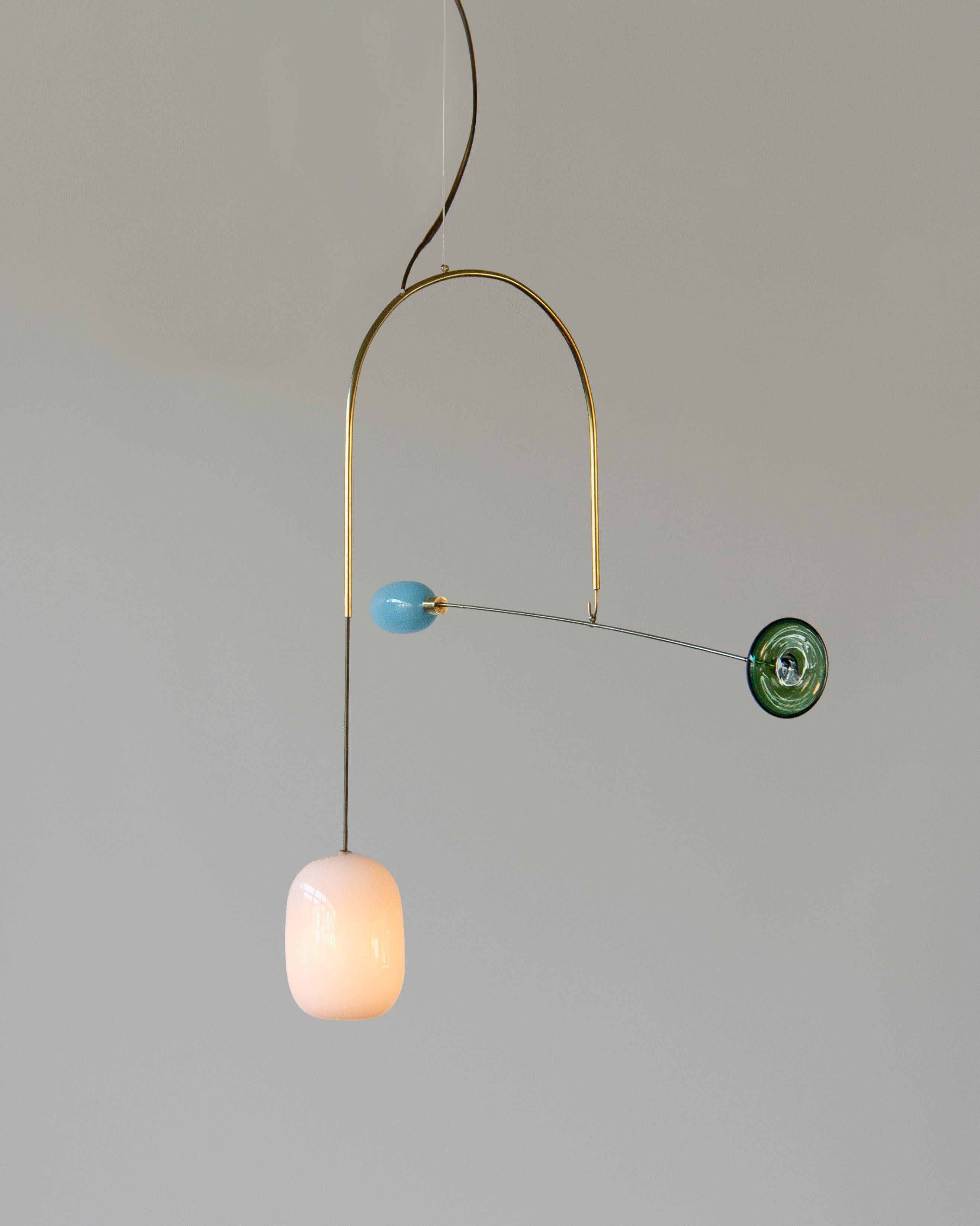 Unique handblown glass pendant by artist Milla Vaahtera. 

Milla Vaahtera is a designer and artist who is most known for her unique pieces combining bold glass parts with delicate brass. After starting with Dialogue -series in 2017, shown in the