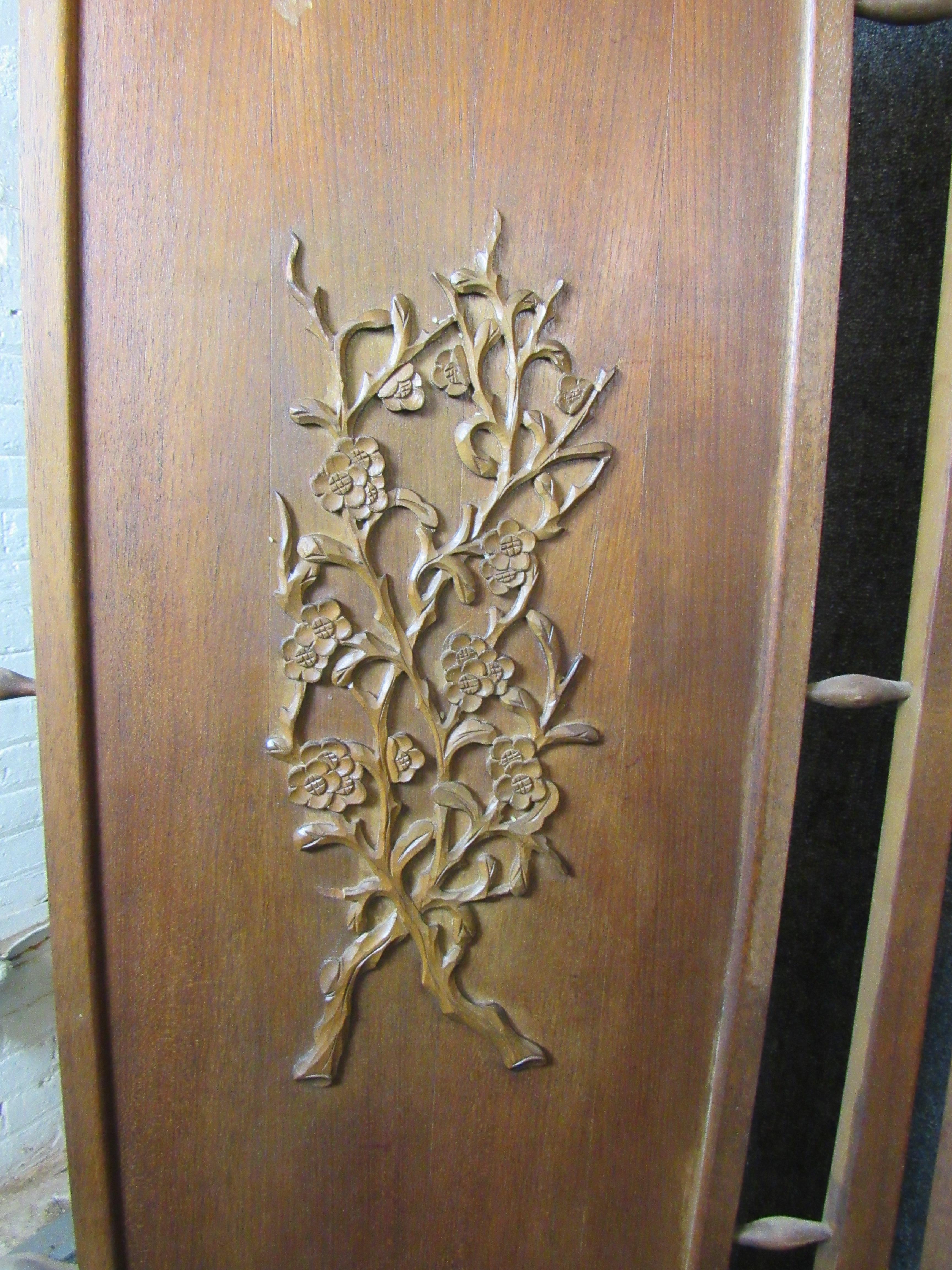 Absolutely stunning walnut room divider featuring gorgeous hand carved floral motifs on each section. Sure to make a statement in any room of the home or office. Folds to a convenient 24