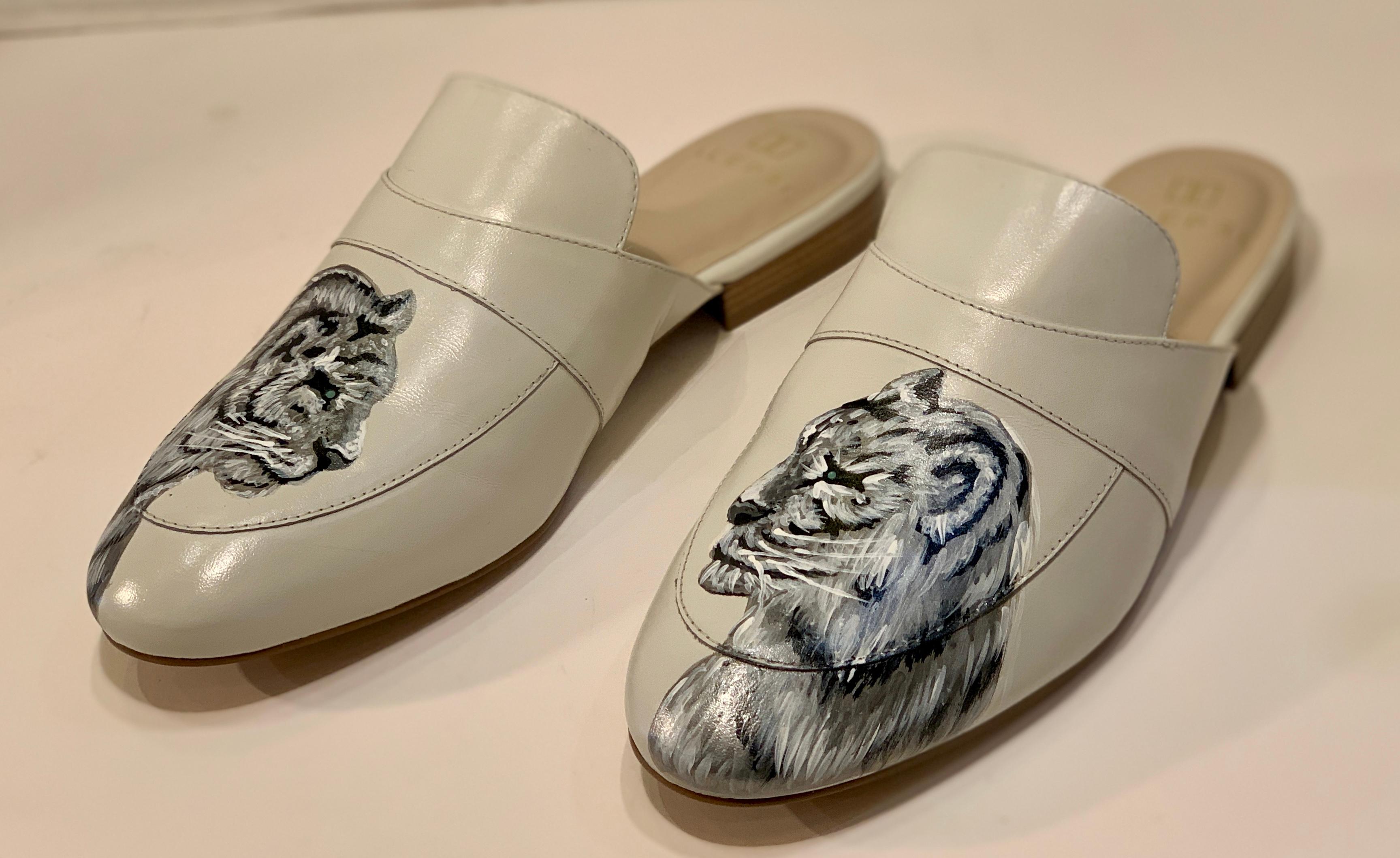 
In a special partnership with Miami-based stylist, Irma Martinez, and ALEPEL, these special edition, elegant mules were designed using the mystique of jungle cats as inspiration.  Hand painted by a Cuban-born ALEPEL artist, the realistic rendering