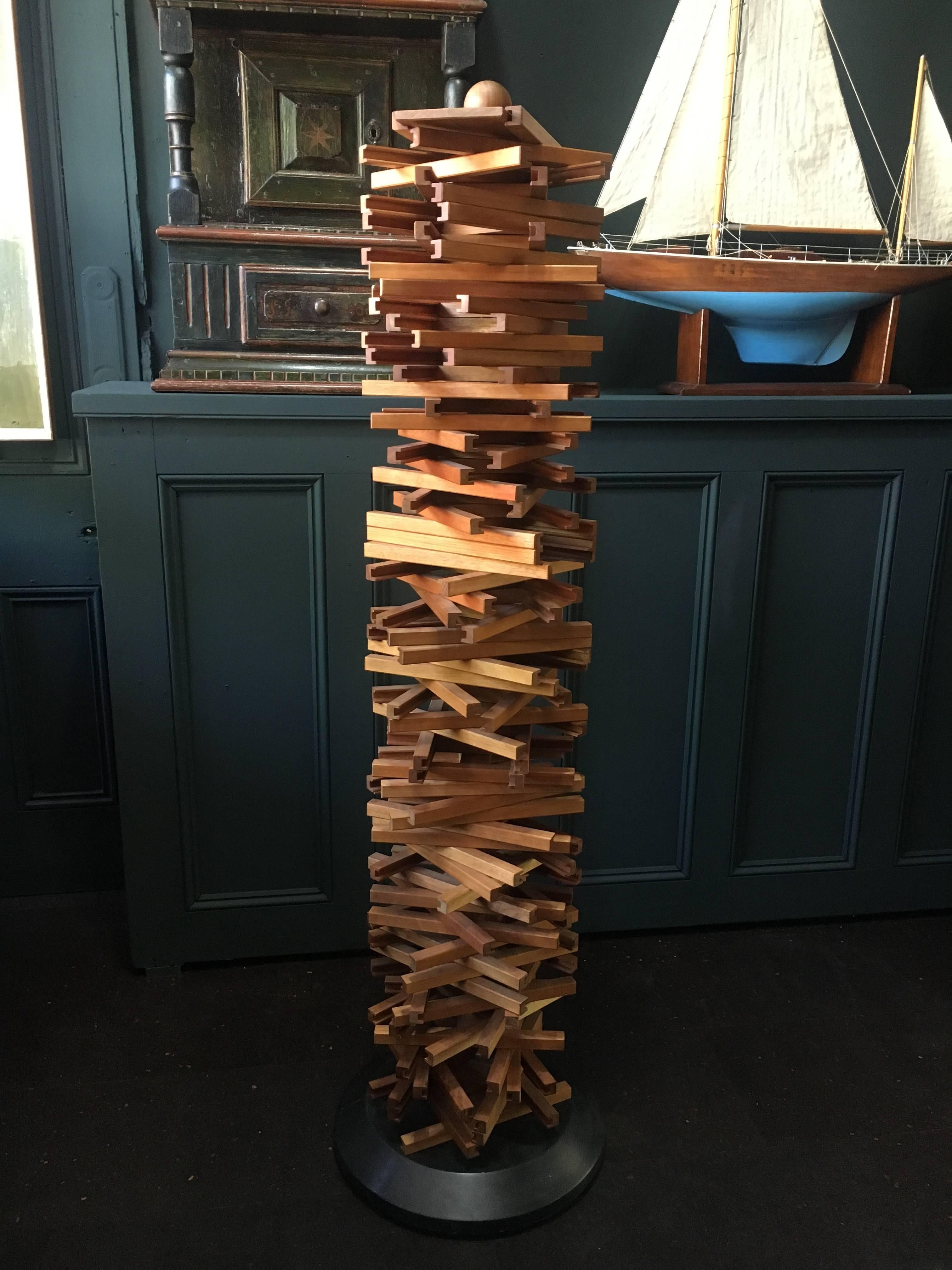 Totally unique CD tower. Handcrafted in Denmark, late 20th century. Constructed in teak the tower pieces can be manipulated to form various shapes and forms. From chaotic Jenga-like stack to dna helix spiral shape. The solid resin base turns on