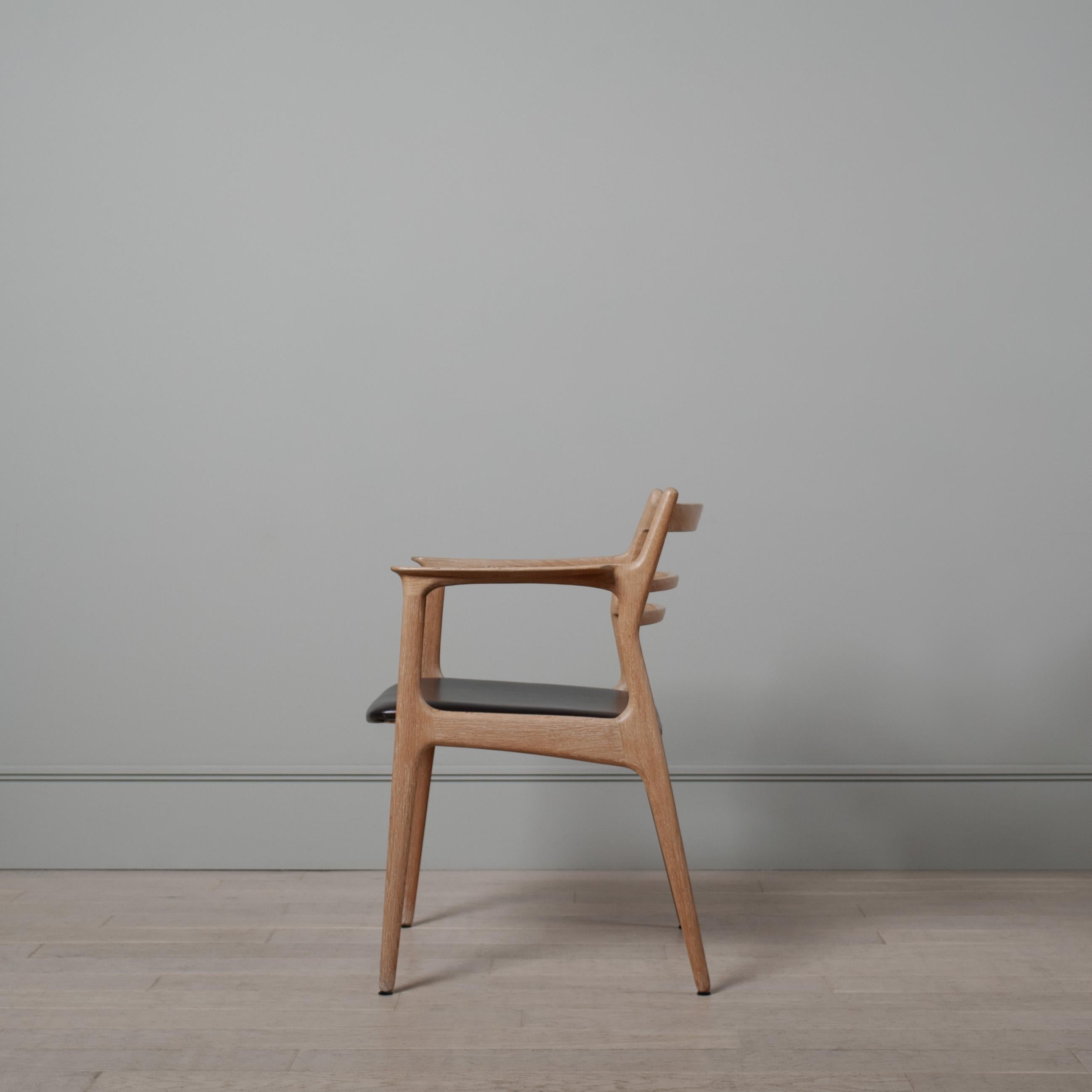 A totally unique oak and leather chair. Striking curved and slick streamlined frame. The oak frame has been thoroughly cleaned and soaped as per the original traditional method. The seat has been reupholstered in black leather - again, as per its