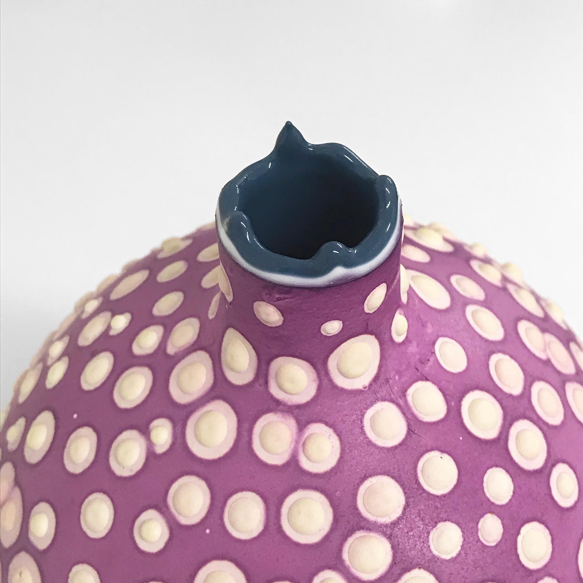 This unusual and playful vase is handmade by artist Elyse Graham in her Los Angeles studio. This collection of vessels is inspired by our incredible and diverse microbiome. The artist is known for her striking color palette and her proclivity for