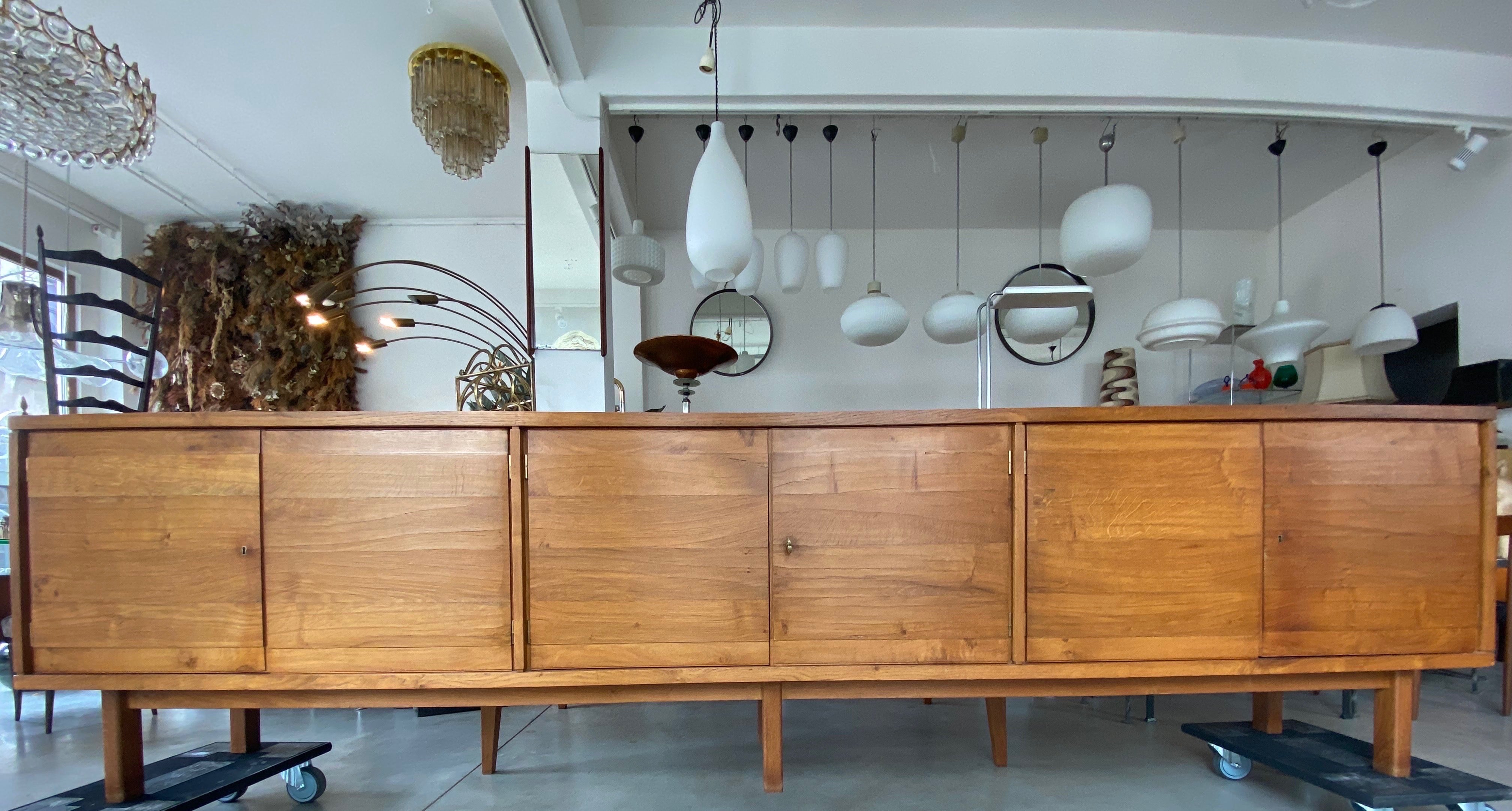 Outstanding sideboard dating from the mid-1950s designed in the style of Emiel Veranneman's 1950s furniture pieces with massive and veneered oak. The characteristic feature of this piece unique sideboard is the consistent development of the lines in
