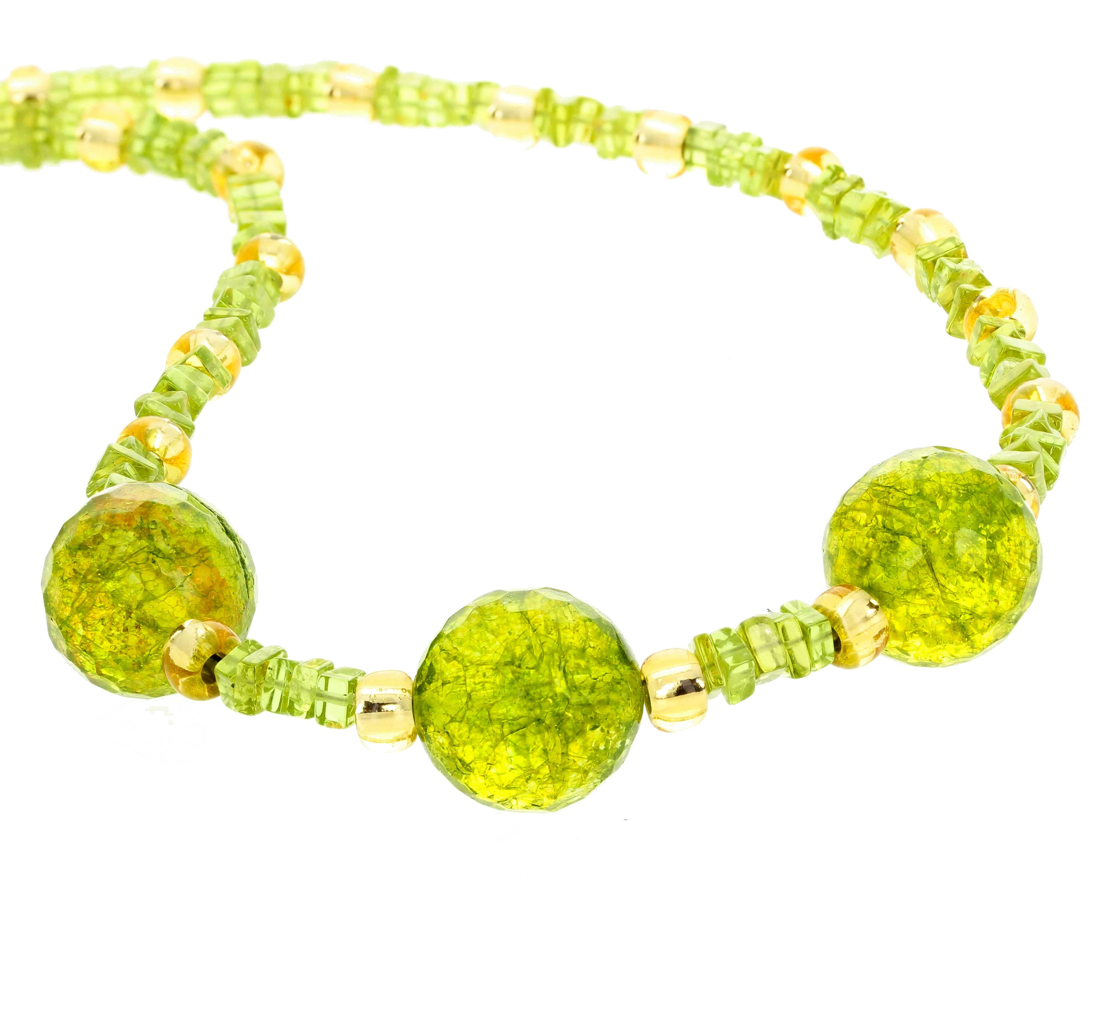 This unique 18 inch long checkerboard gem cut and polished glittering brilliant Peridot necklace is enhanced with sparkly goldy Crystals and set with a hook gold plated clasp.  The larger Peridot are approximately 15mm round and the smaller cube