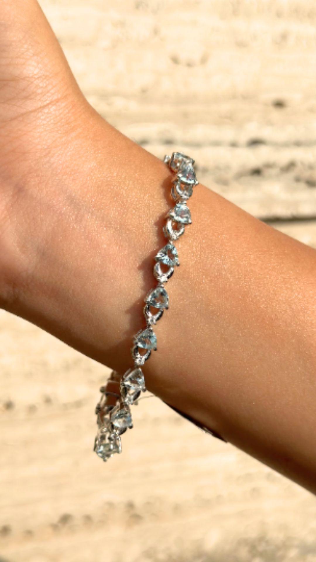 Unique Heart Cut Aquamarine Bracelet in sterling silver showcases endlessly sparkling natural aquamarine, weighing 9.55 carat. It measures 7.25 inches long in length. 
Aquamarine stimulate concentration and reduces stress. 
Designed with perfect