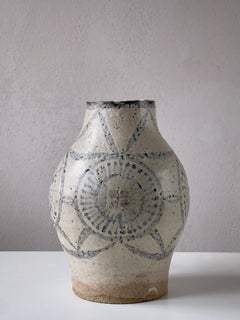 Unique heavy danish stoneware vase with beige glaze and faded blue decoration.
