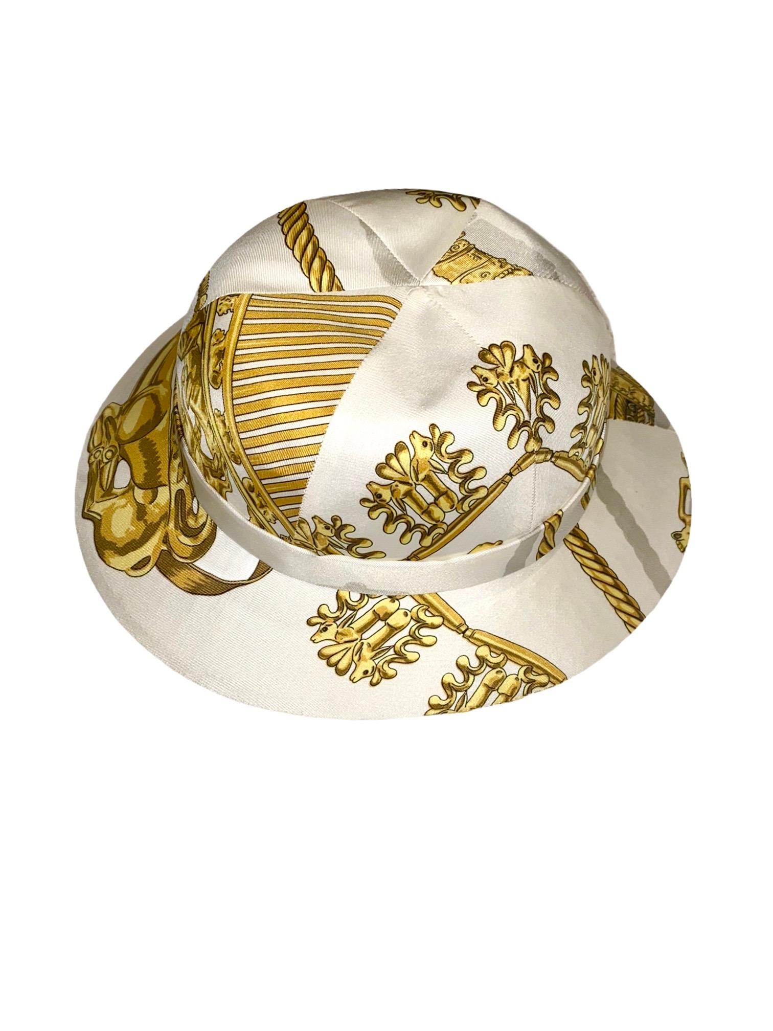 
Beautiful HERMES printed silk twill structured safari hat

Unique, rare piece
Off white background with gold Greek Scythian art jewelry print throughout
Fully lined in white silk
Made in France
Dry clean only

Rare print by Hermès 