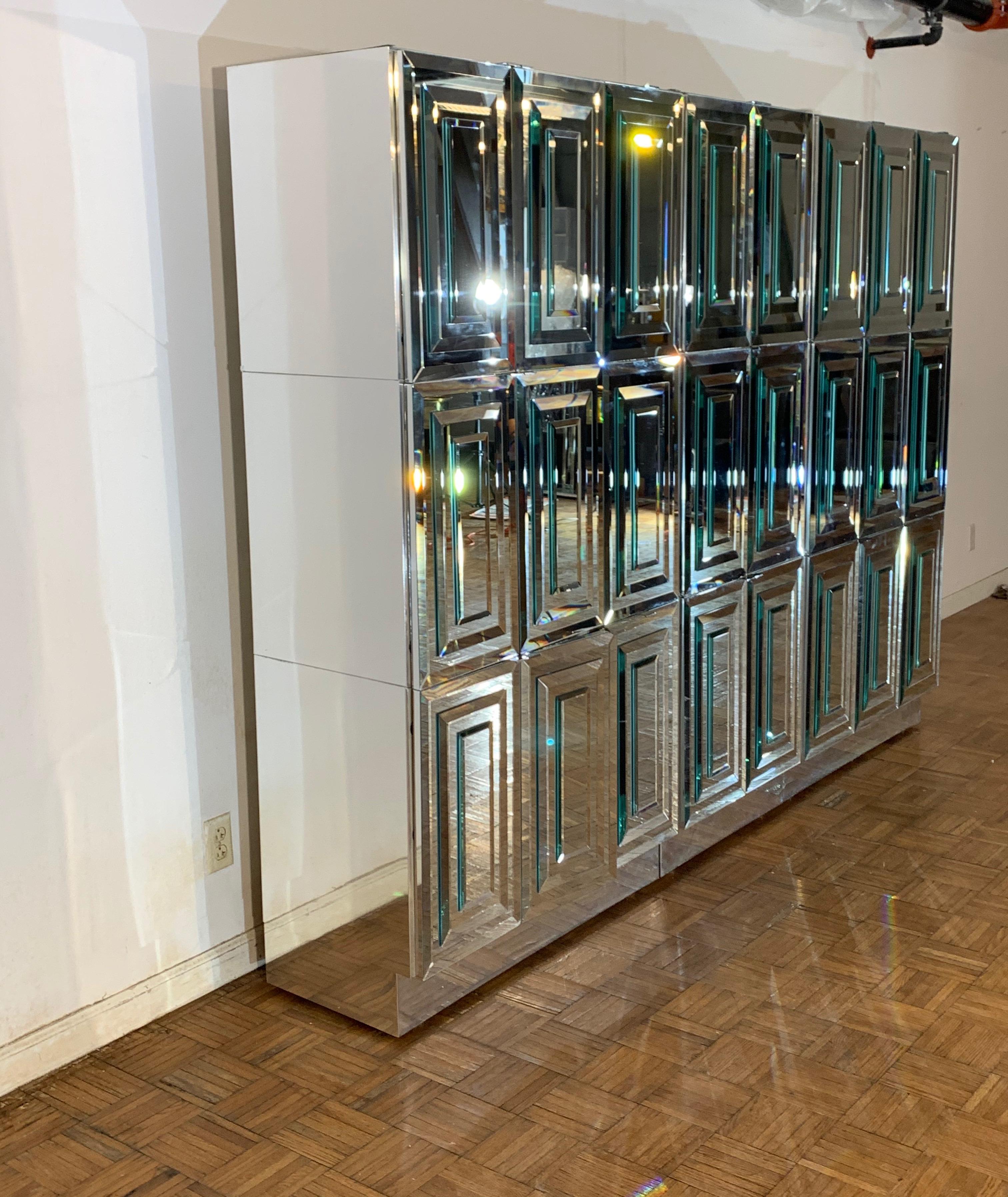 Unique custom ordered Mid-Century Modern Ello Furniture breakfront or sideboard with beveled mirrored doors polished chrome sides, includes dry bar and internal shelves and drawers. This wall of storage is comprised of 9 individual components,