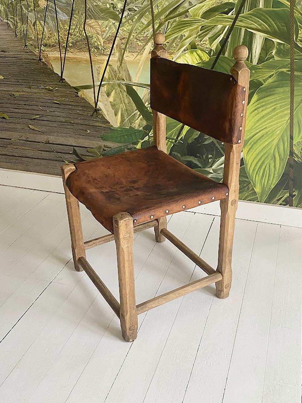 This exceptional, vintage chair is a masterpiece of Hungarian craftsmanship, once serving in the ceremonial hall of the Szentendre Town Hall. Its solid wooden frame radiates warmth and natural charm, while the riveted, aged leather seat and backrest