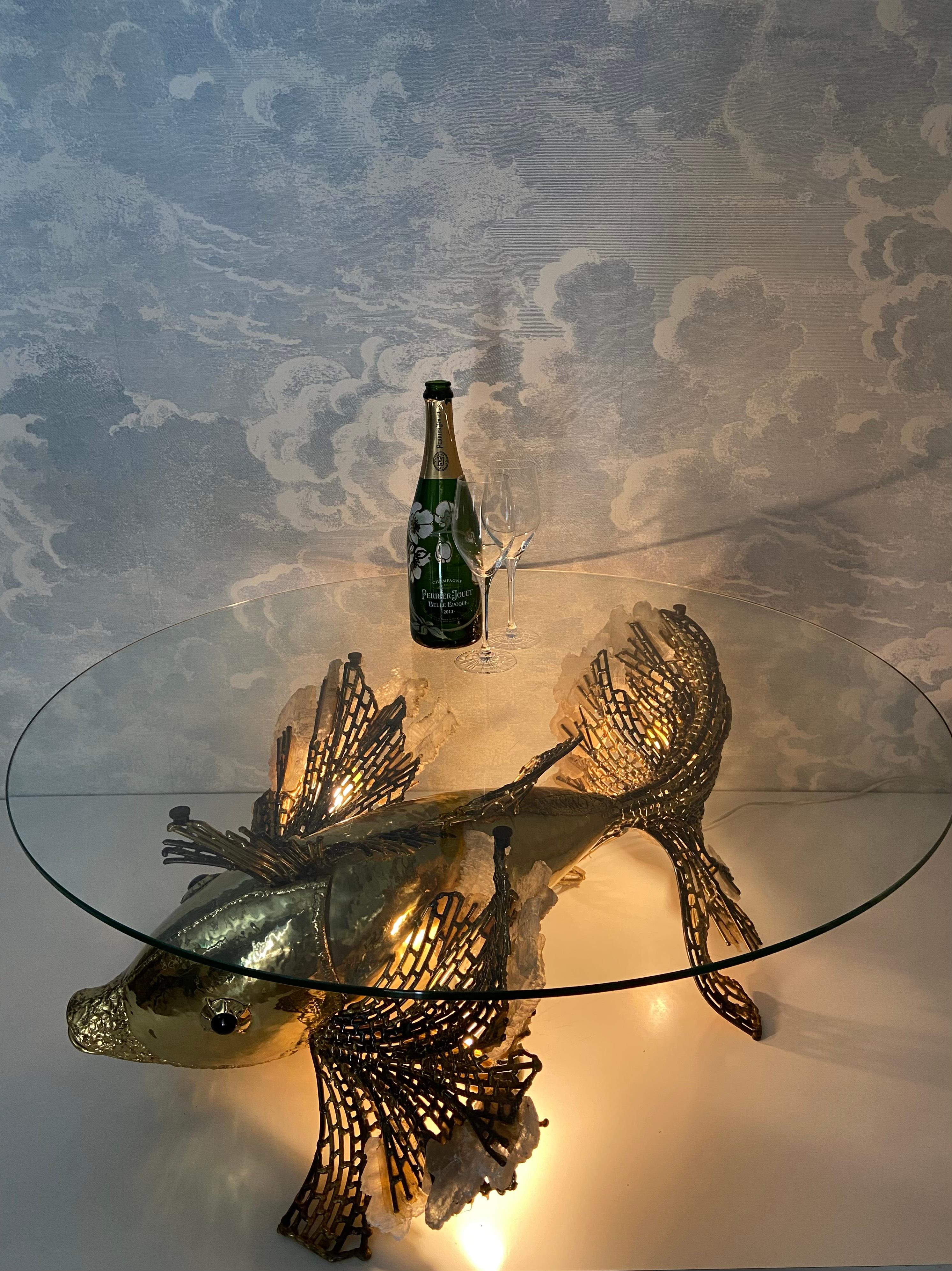 This exceptionally rare illuminated fish sculpture serves as an extravagant sofa table and is attributed to the French designers Isabelle & Richard Fauré. It most likely hails from the illustrious Maison Honoré in Paris, known for their remarkable