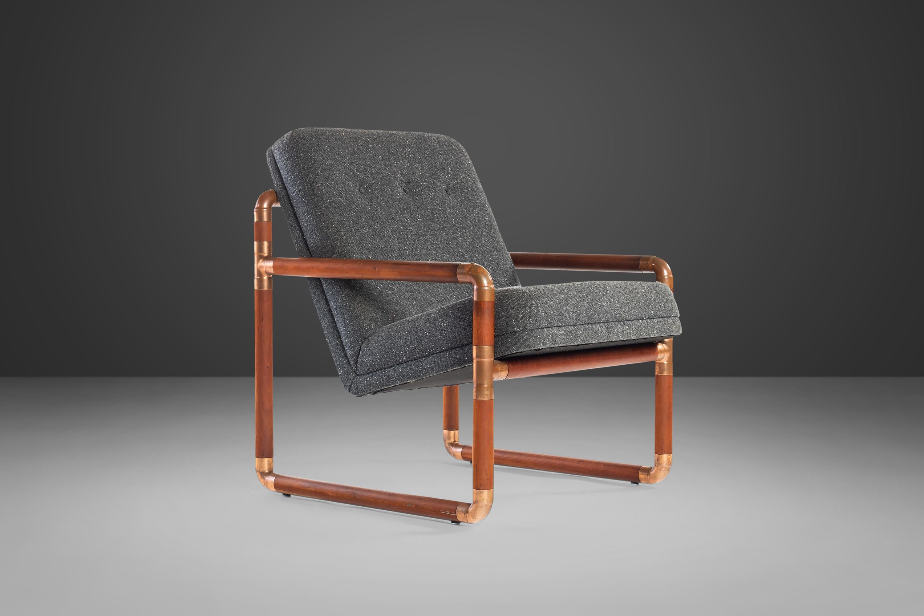 This extraordinary lounge chair is unlike any we've ever seen and is as comfortable as it is unique. Built of solid walnut with solid brass couplings this armchair is truly one of a kind. Upholstered in a fabulous grey tweed this BOLD loveseat is