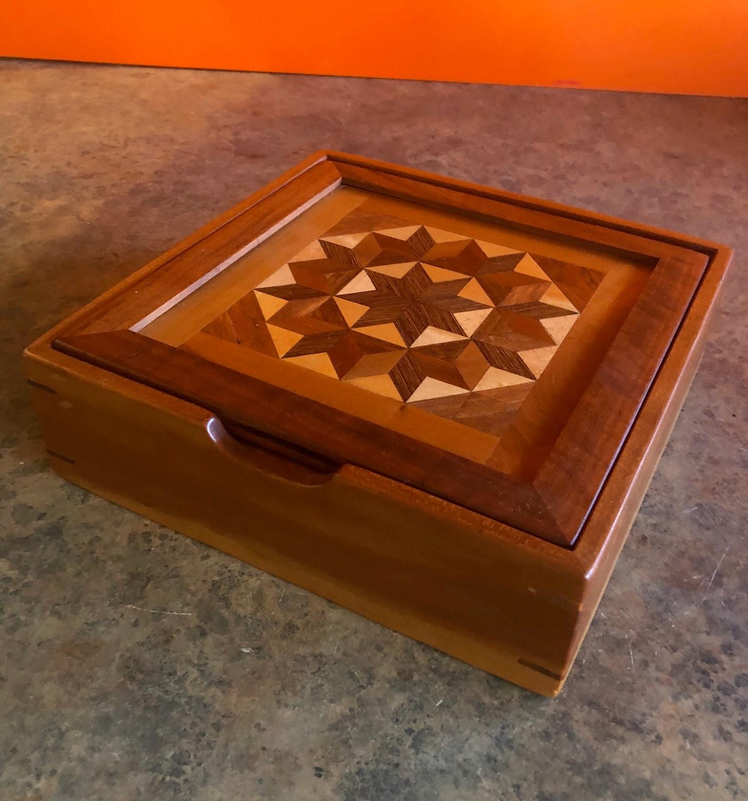 Unique inlaid marquetry box made from a number of hardwoods. Wonderful handmade piece with a great symmetrical 
