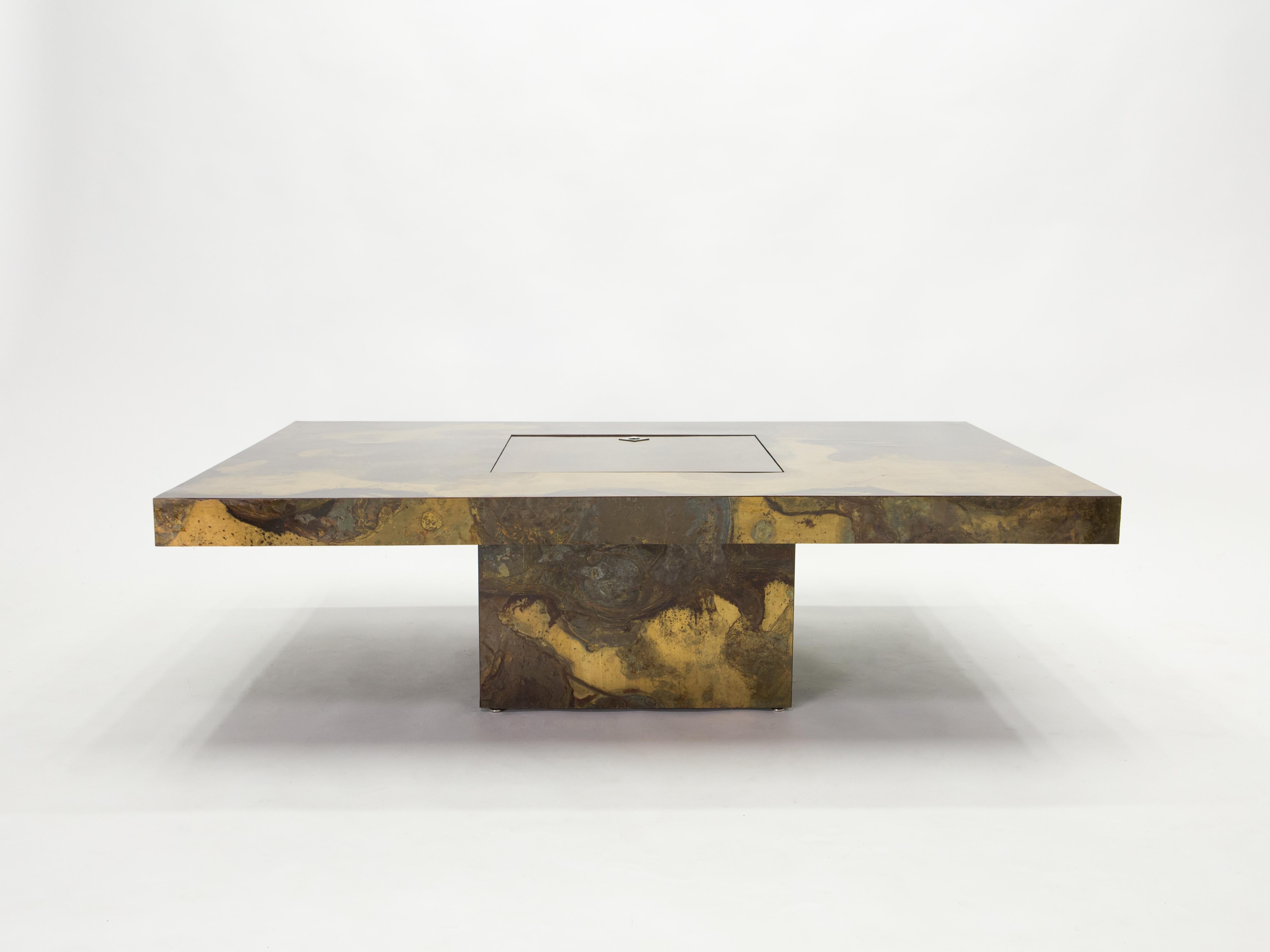 This unique large coffee table was created by Isabelle and Richard Faure for Parisian design firm Maison Honore in the late 1970s. Entirely covered by an incredibly decorated oxidized and patinated brass all over, that was then fixed and varnished.