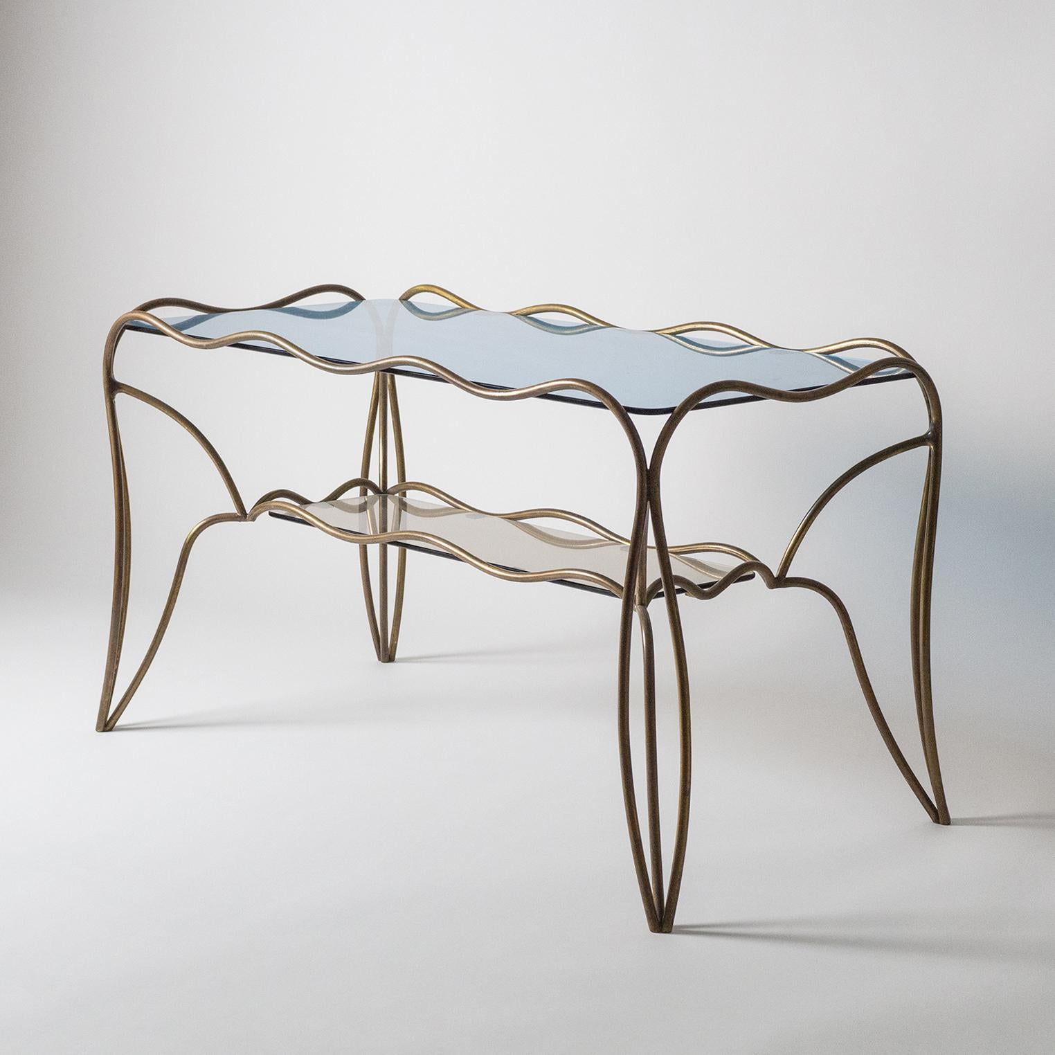 Very unique midcentury Italian cocktail or side table in brass with dual colored glass tops. The frame is made of an intricate structure of ondulating brass with a blue glass top and a bronze colored glass on the second level. A very exceptional