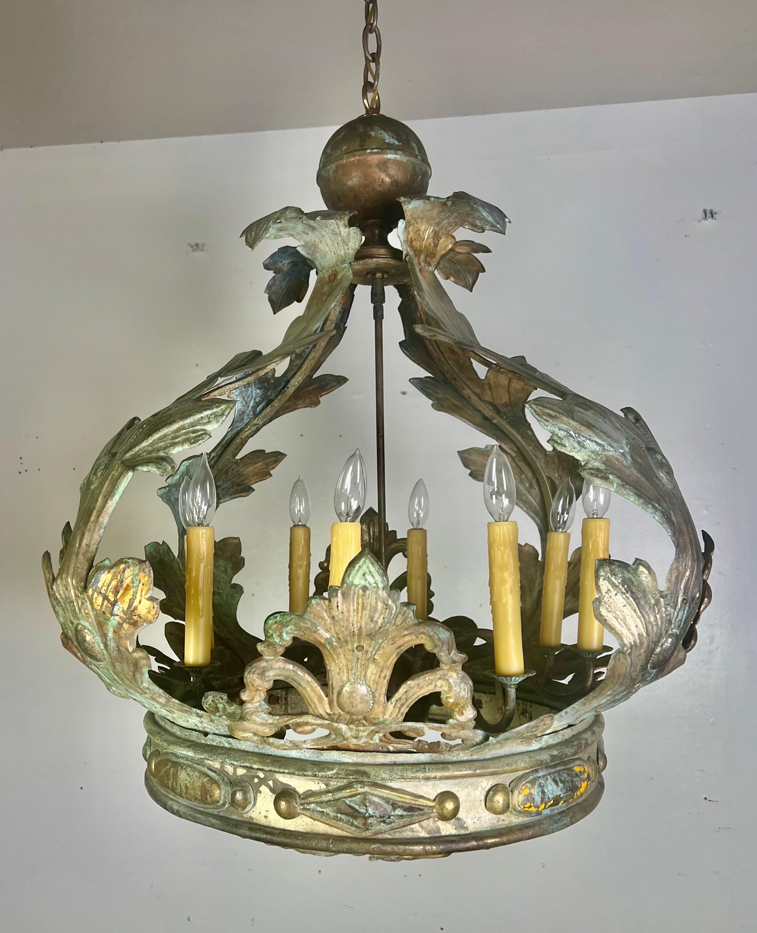 An 19th-century toll chandelier with acanthus leaves and a diamond-shaped design at the base, showcasing an incredible patina.  The crown was retrofitted into an 8-light chandelier with wiring and a canopy.  It is remarkable and ready-to-install. 