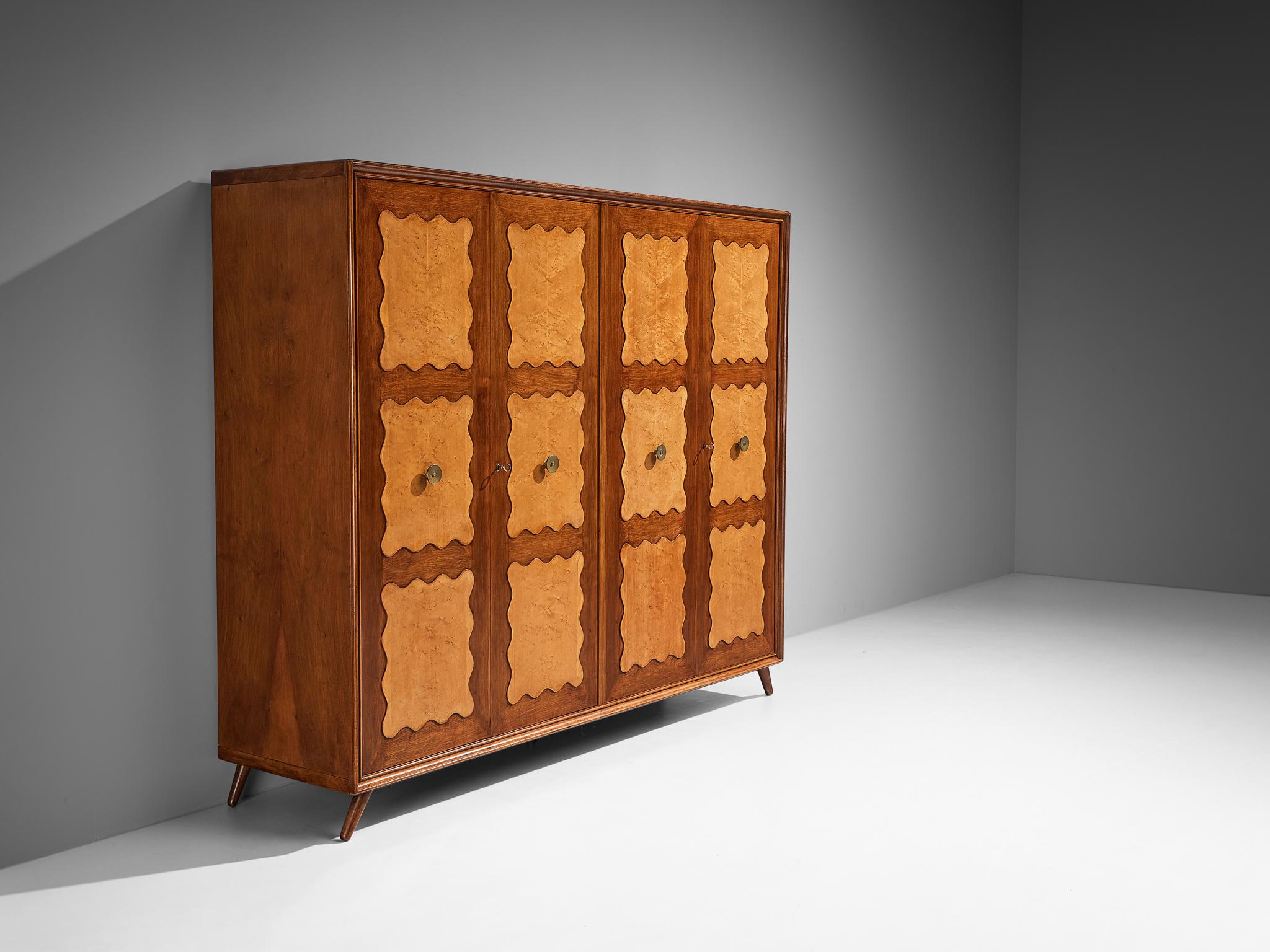 Wardrobe, walnut, birch, beech, brass, mirrored glass, steel, aluminum, Italy 1940s/1950s

The decorative elements, material use, woodworking, and the overall composition suggest that this armoire might have been crafted by an Italian master. This