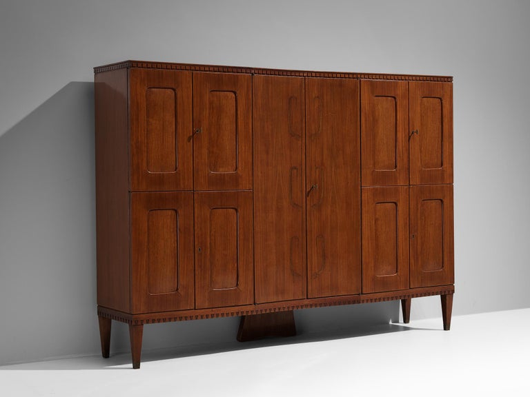 Attributed to Paolo Buffa, wardrobe, mahogany, brass, mirrored glass, glass, Italy, 1950s

The decorative elements, materials use, woodworking, and the overall composition suggest that this cabinet might have been crafted by the Italian master