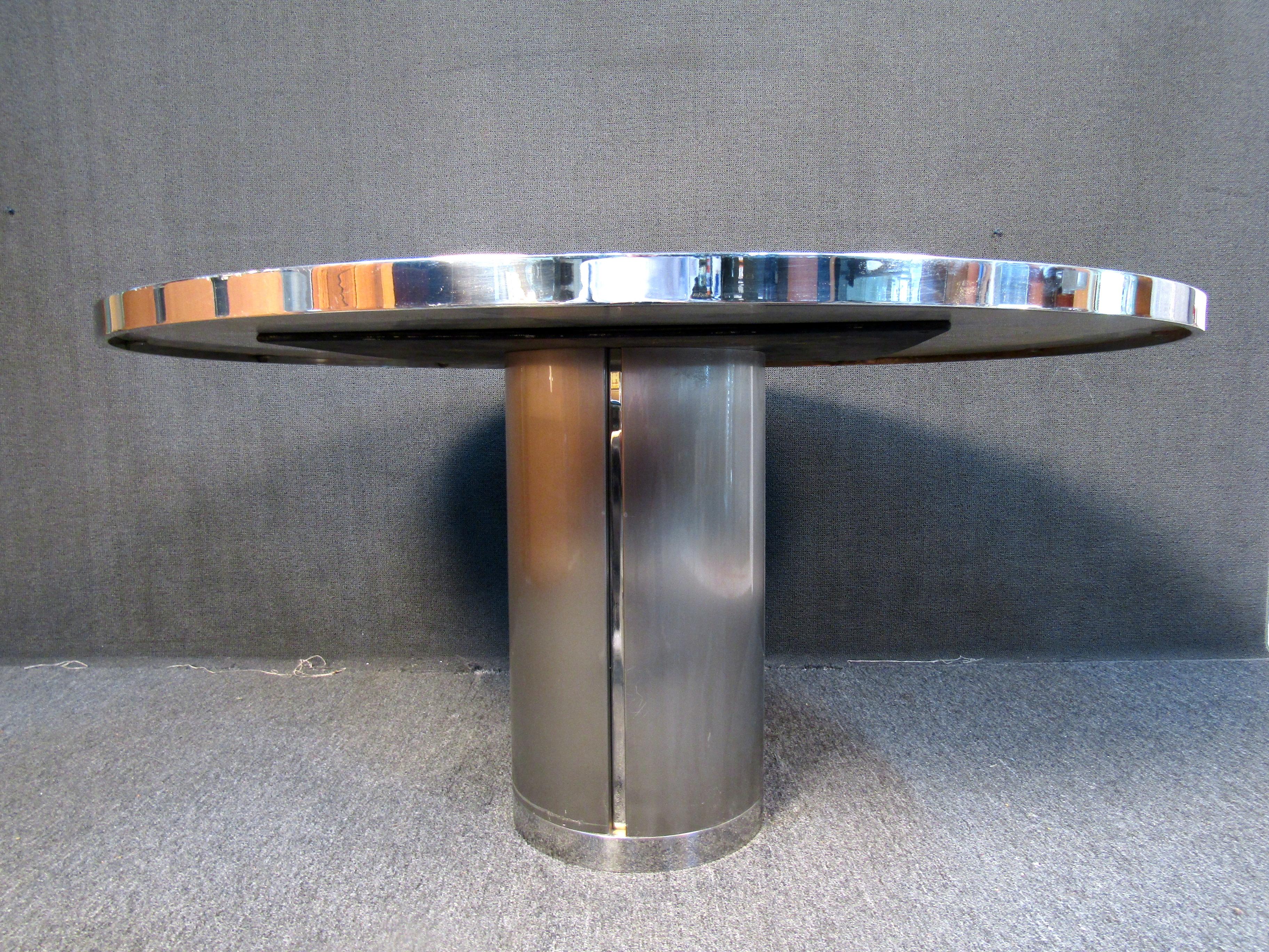 A unique piece featuring all metal and chrome appearance with a cylindrical base. A one of a kind table that would be the topic of conversation in any living space. Please confirm item location with seller (NY/NJ).