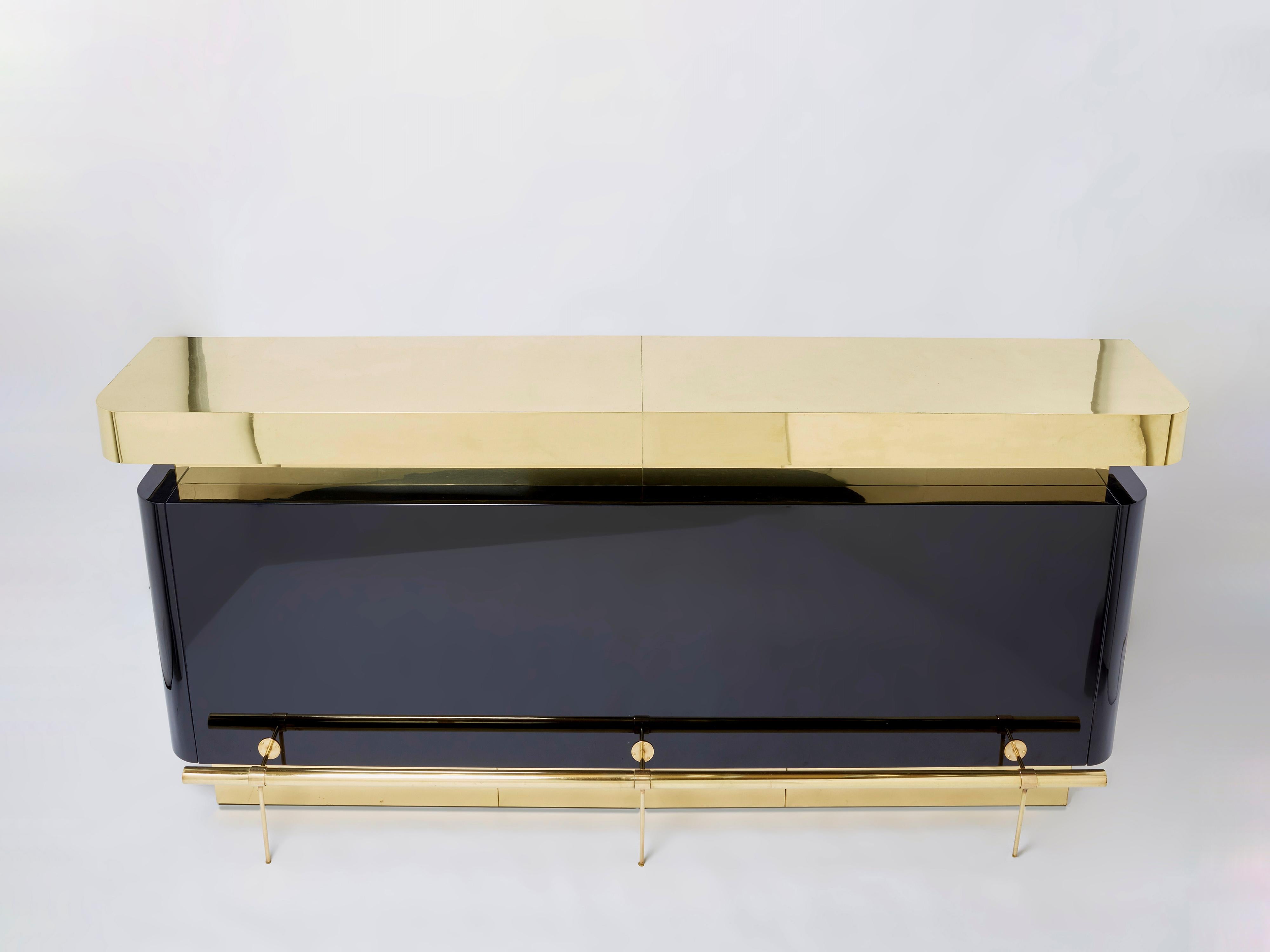 A unique bar for a standout look. This rare piece was designed by Jean-Claude Mahey in the 1970s for Maison Romeo Paris, and displays all the trademark glam of the French seventies period. Brass and black lacquer are used in large, chunky blocks for