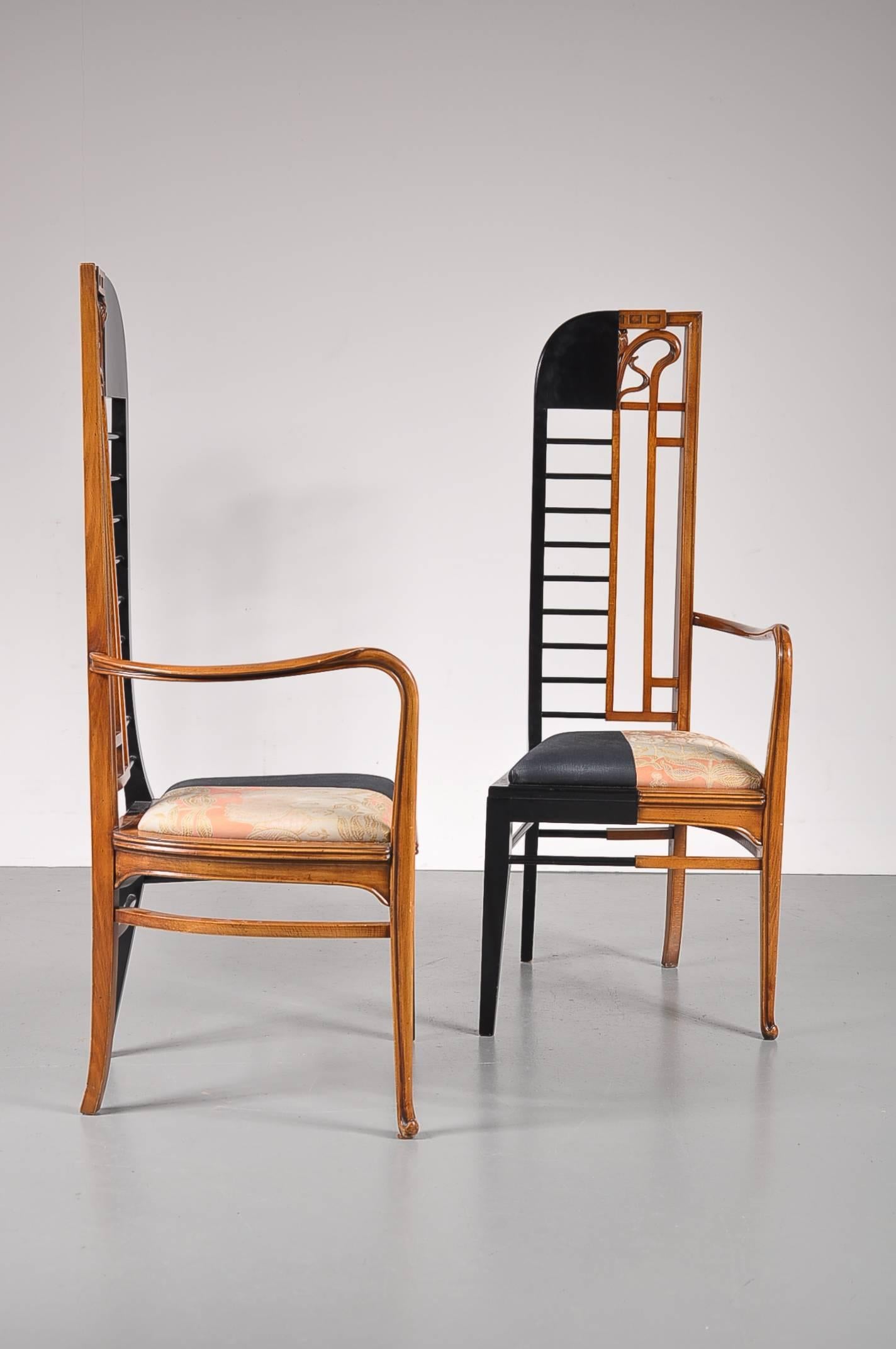An exceptional pair of chairs that combines two styles in a truly unique way! They were used in a town hall's wedding room. Produced in the Netherlands in the 1980s.

One half of each chair is made from high quality brown colored wood, with