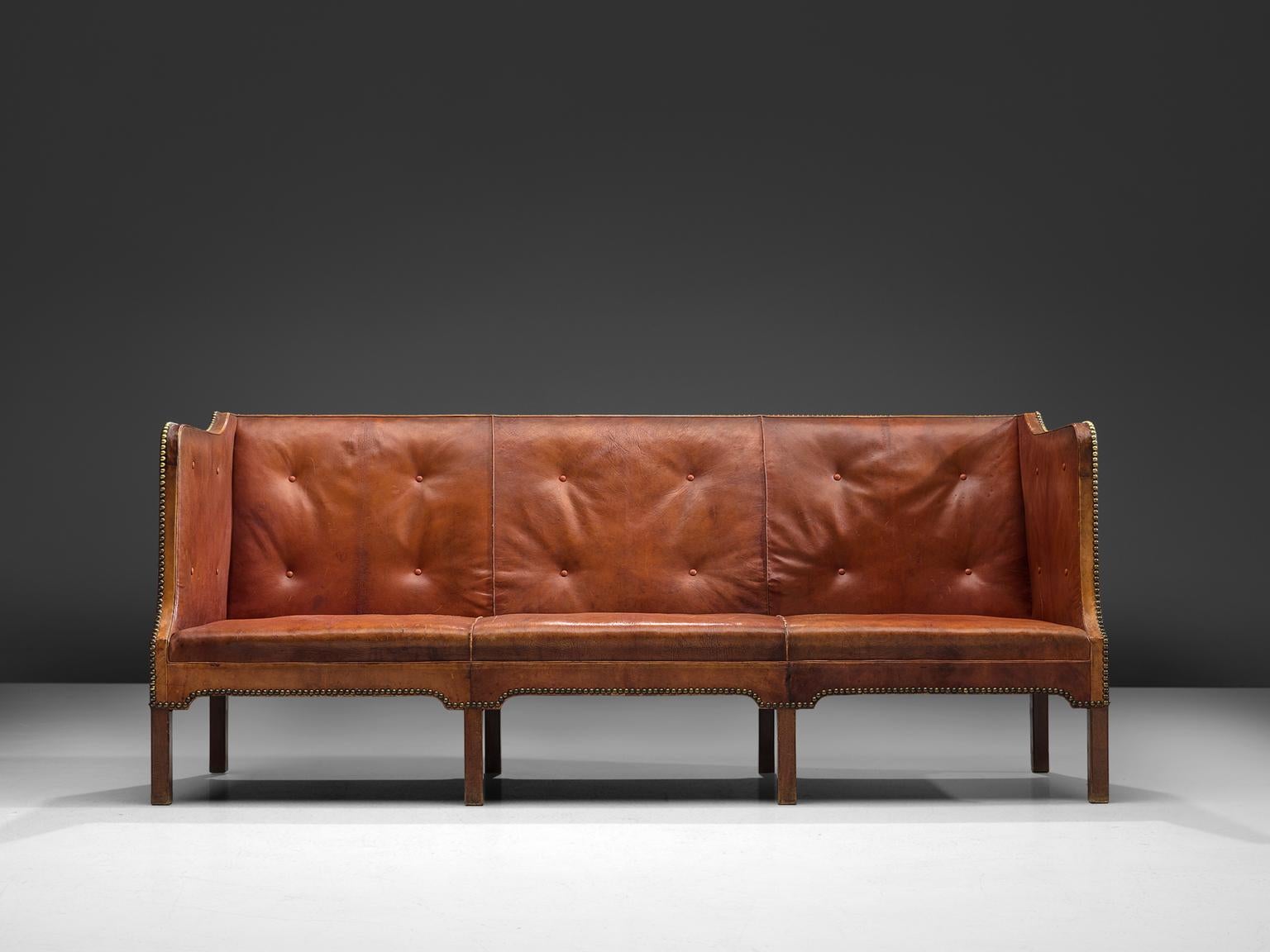 Kaare Klint, variation on sofa model 4118, cognac leather and Cuban mahogany, late 1920s, Denmark.

Classic and elegant Scandinavian custom made three-seat sofa by Kaare Klint for Erik Zahle, the late director of the Danish Design museum from 1949