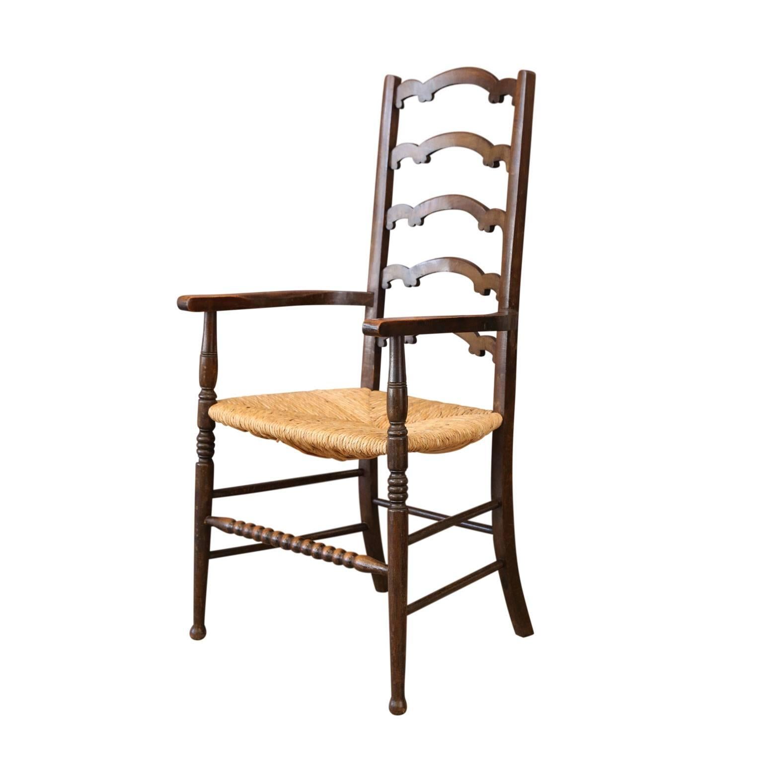 Unique ladder-back chairs carved with unusual, almost whimsical, scallop-shaped back splats, nice curved arms and a front turned bobbin stretcher. Chairs' nice dark finish is naturally worn in all the right, and expected, places (front stretcher,