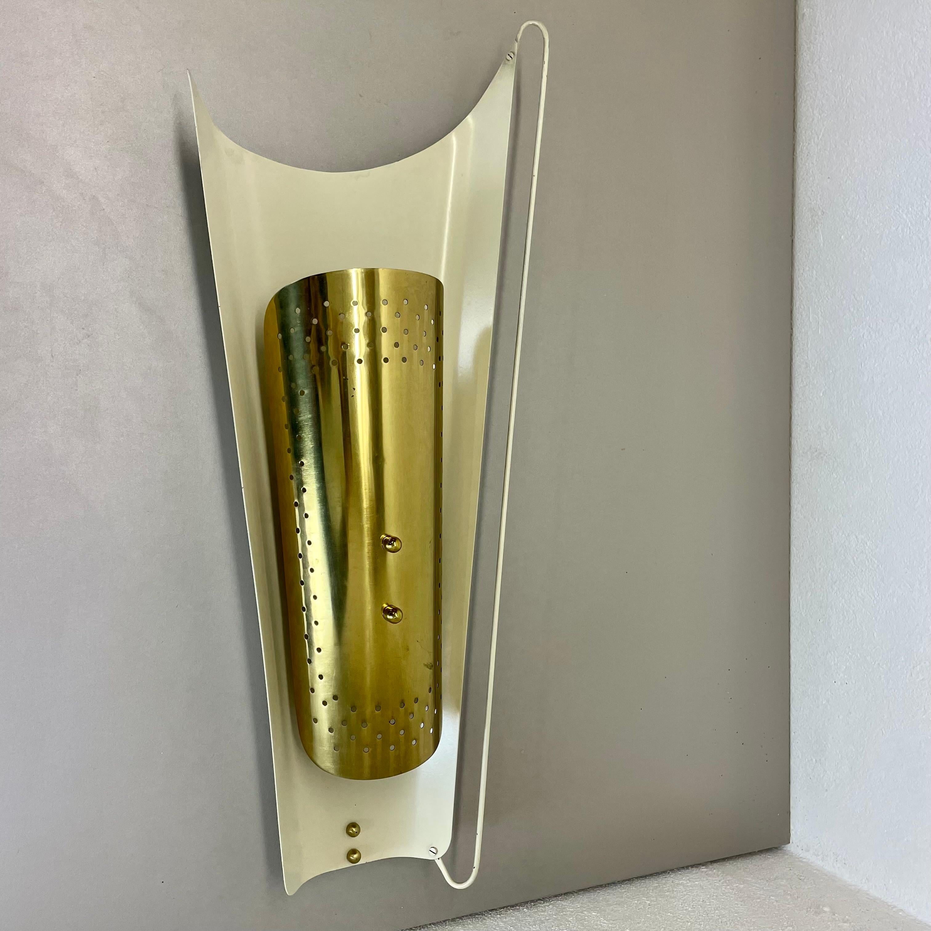 Article:

brass theatre wall light sconces



Origin:

Italy



Age:

1950s


This modernist light was produced in Italy in the 1950s in Italy. It is made of brass tone metal and metal on the wall fixation element. it features a very unique and