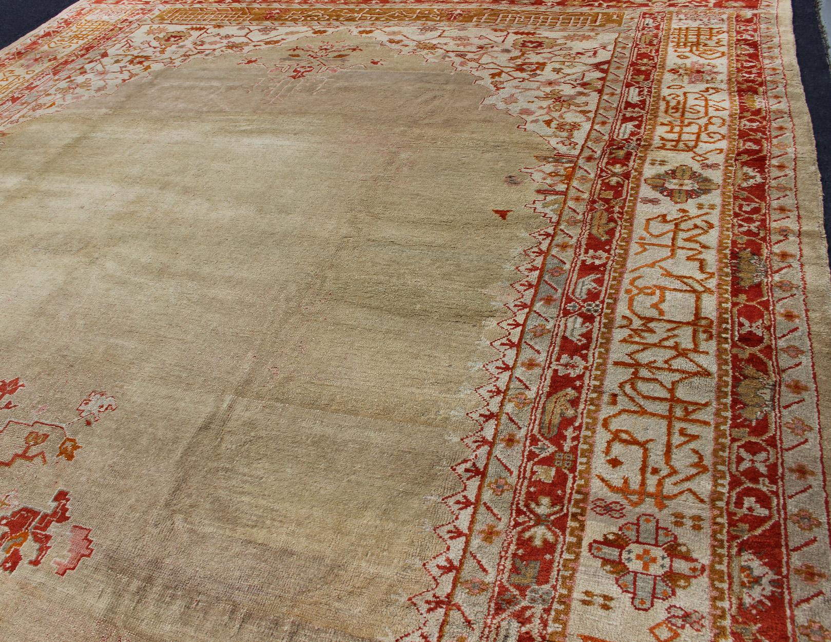 Large Antique Oushak Rug in Taupe / Light Green Background and Red Border In Good Condition For Sale In Atlanta, GA