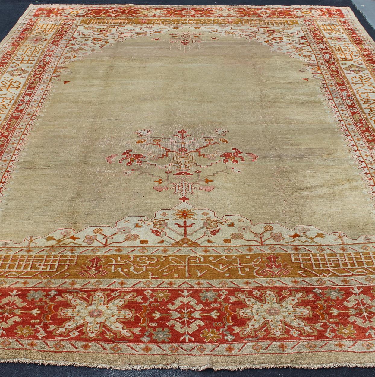 20th Century Large Antique Oushak Rug in Taupe / Light Green Background and Red Border For Sale