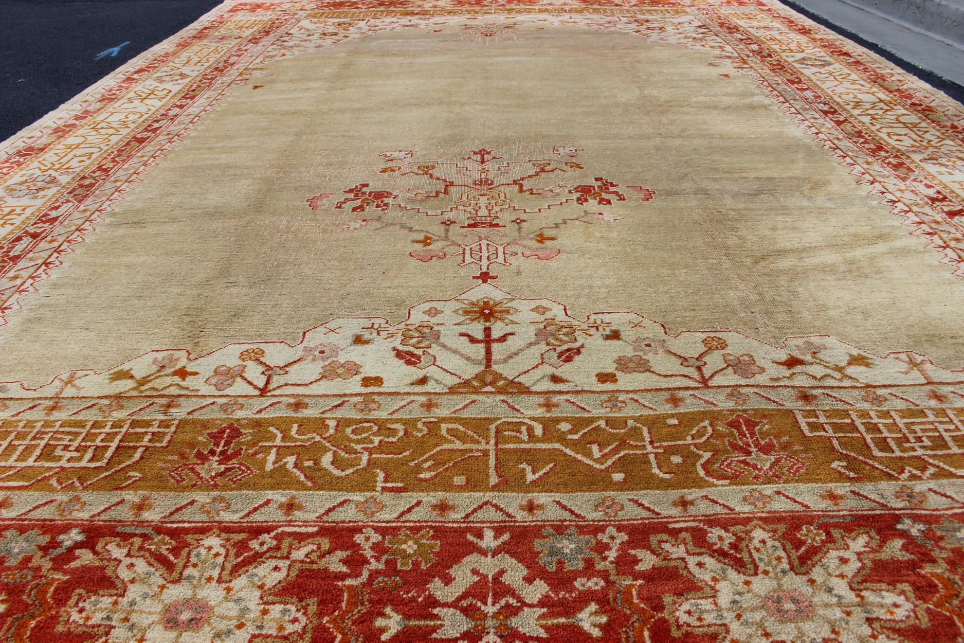 Wool Large Antique Oushak Rug in Taupe / Light Green Background and Red Border For Sale