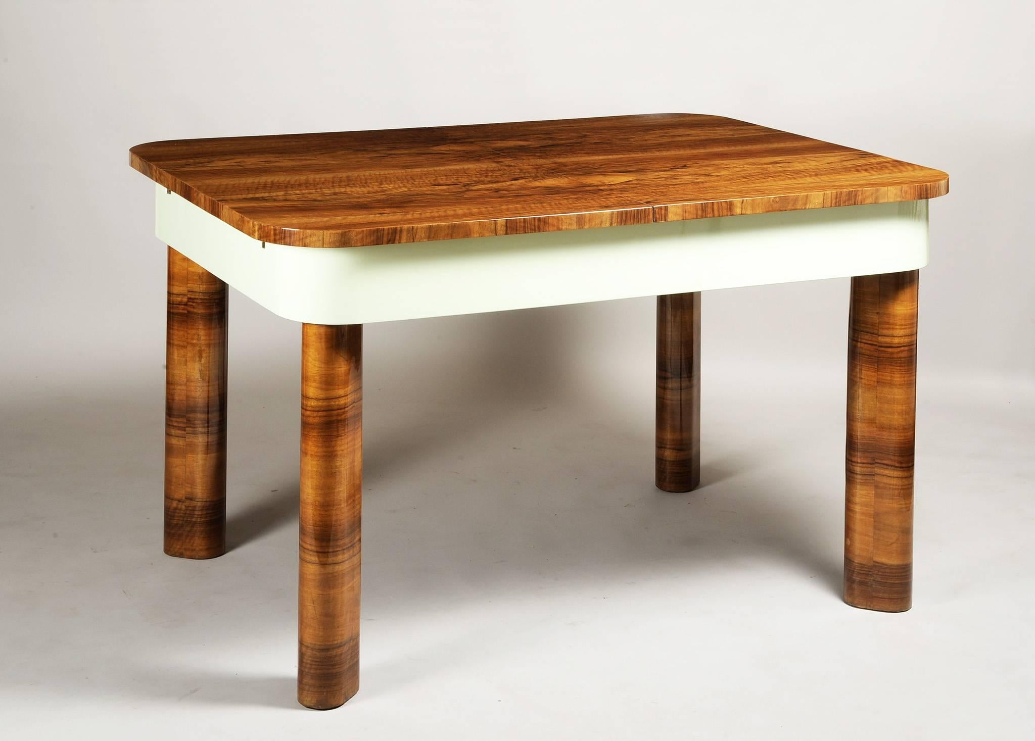 Extendable dining table
Material: Walnut
Completely restored.
Surface polished by piano lacquers to the high gloss. 

The spread table has a width of 180 cm
  
We guarantee safe a the cheapest air transport from Europe to the whole world within 7