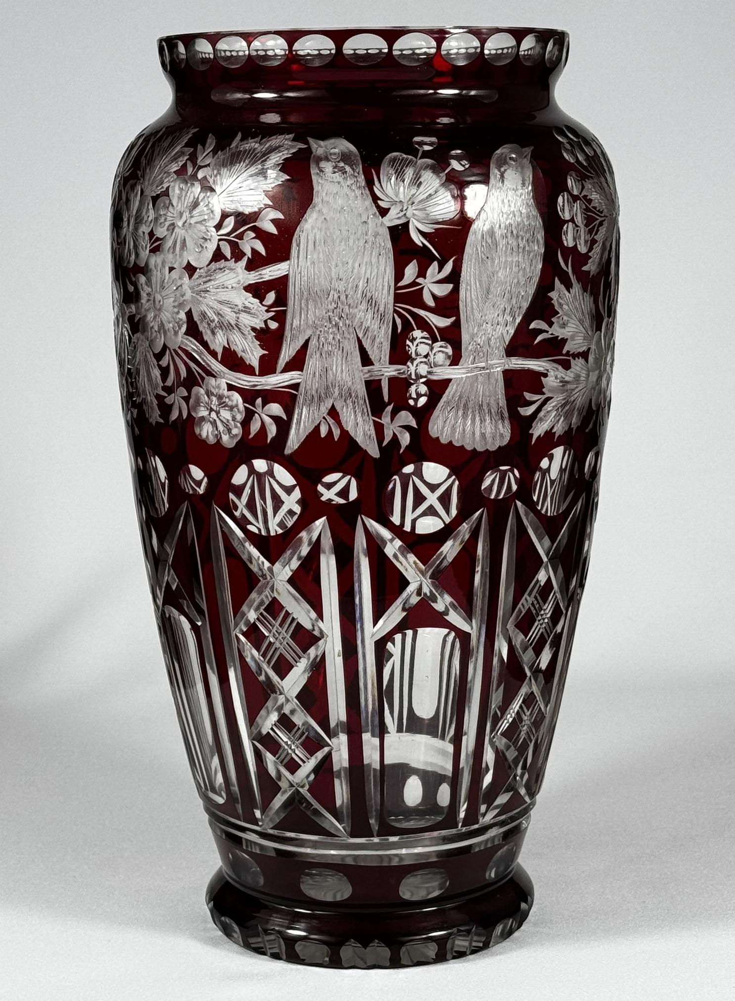 Very beautiful large vase made of clear glass with overlay of ruby glass. The vase is cut with polished engraving, motif of plants, flowers and birds. It is a beautiful work of Czech glass masters of the 20th century. A beautiful addition to the