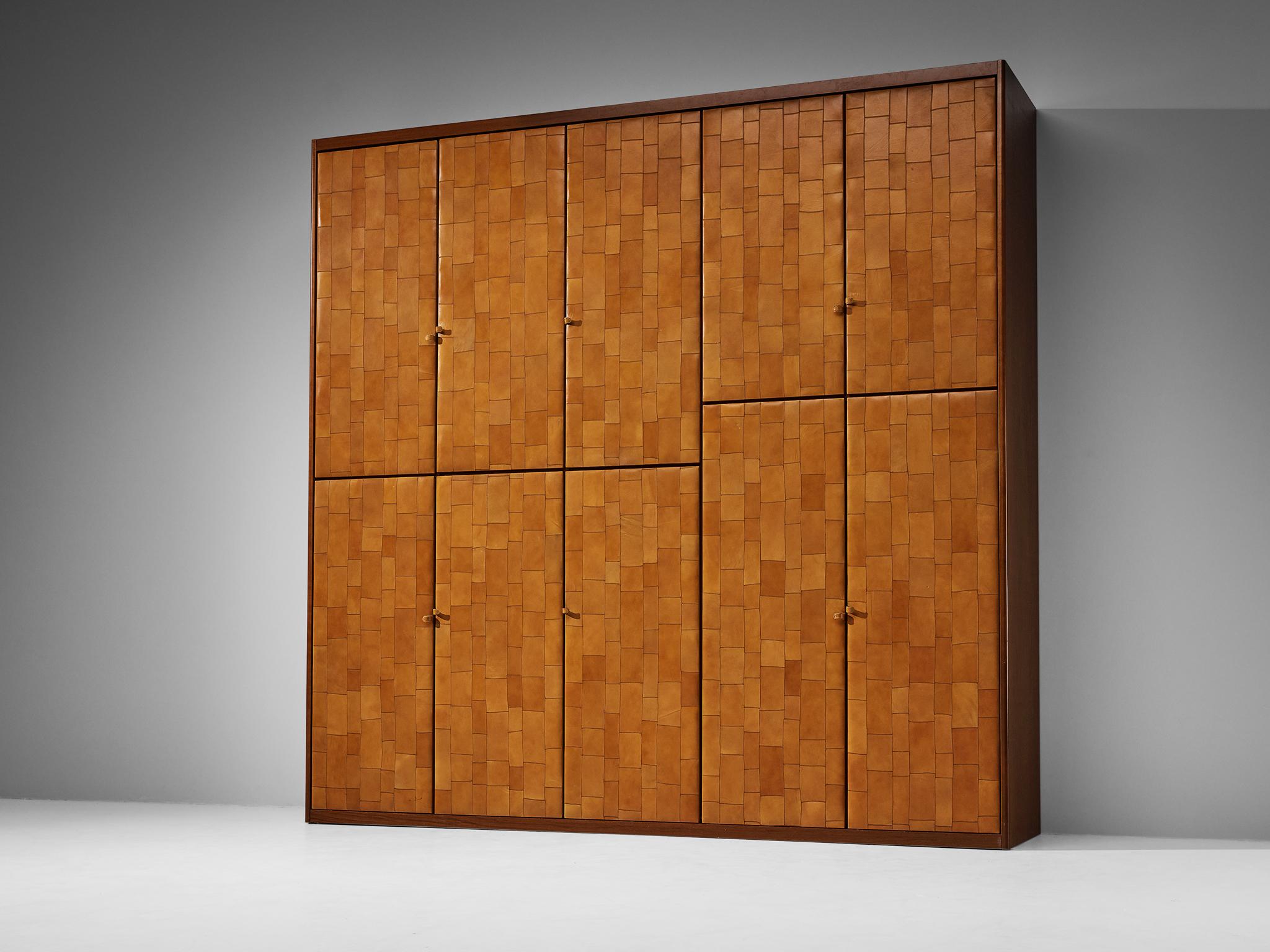 Wardrobe, patchwork cognac leather, stained birch, metal, Italy, 1970s.

This is an eye-catching wardrobe that has been made in Italy in the 1970s. The entire body of the piece is covered in a patchwork cognac colored leather, that has great