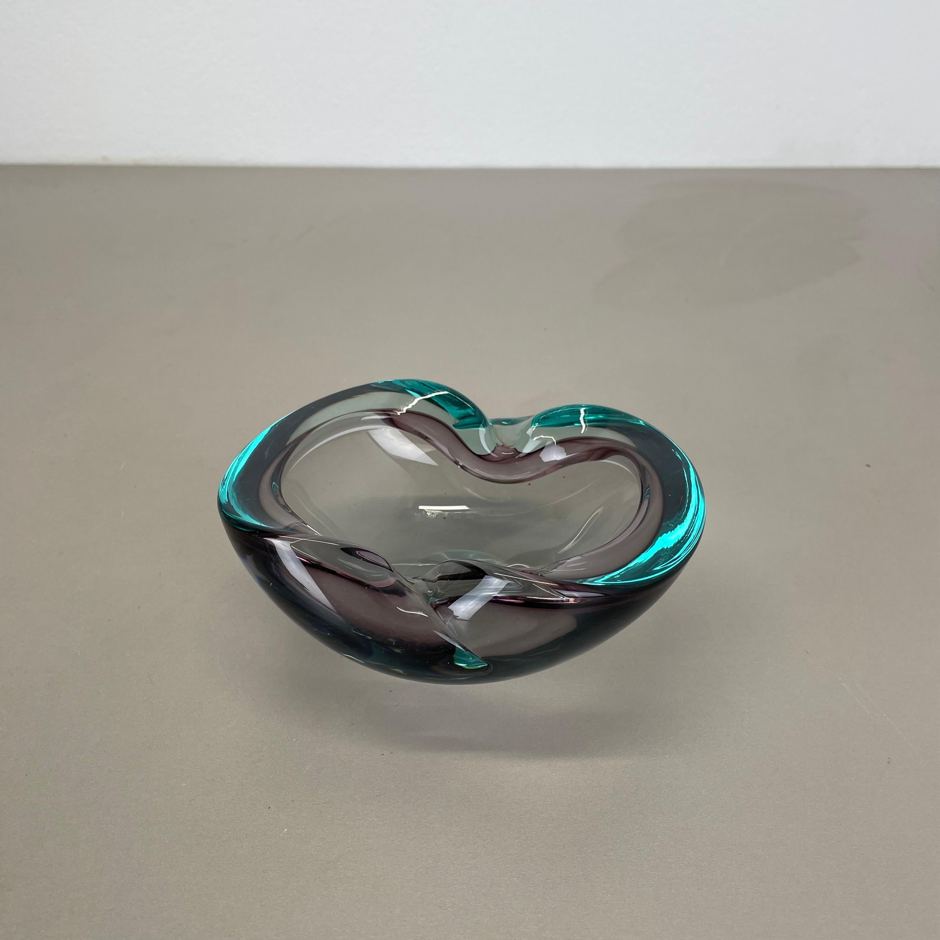 Article:

Murano glass bowl element  ashtray


Origin:

Murano, Italy


Decade:

1970s


This original glass element was produced in the 1970s in Murano, Italy. An elegant multicolor Murano glass element with an organic shaped form. The main color