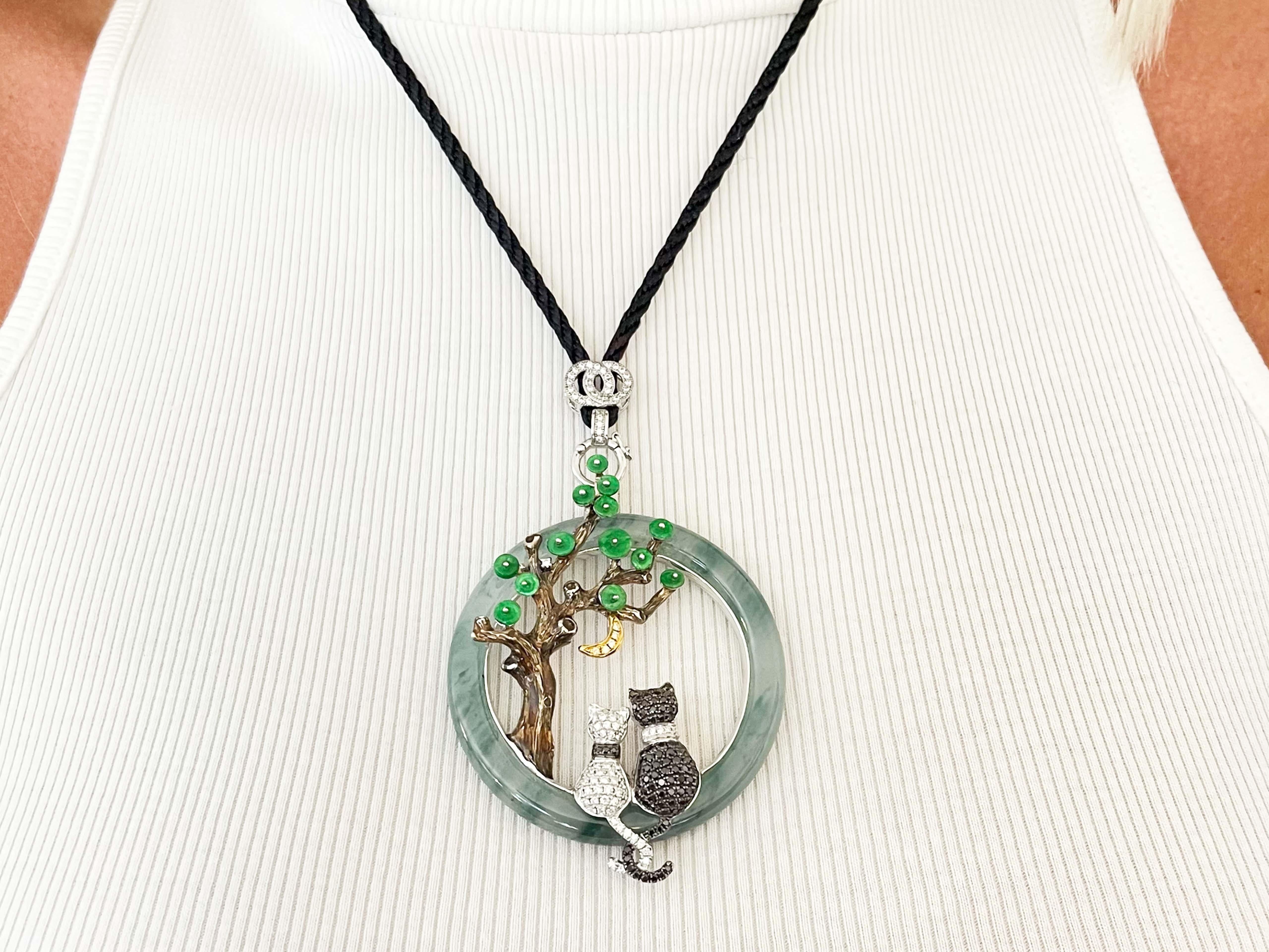 This unique one-of-a-kind pendant features 0.90 carats of black diamonds and 0.55 carats of white diamonds. There is a total of 20 carats of jade featuring water jade and apple jade on the tree made with brown enamel. The moon features fancy intense