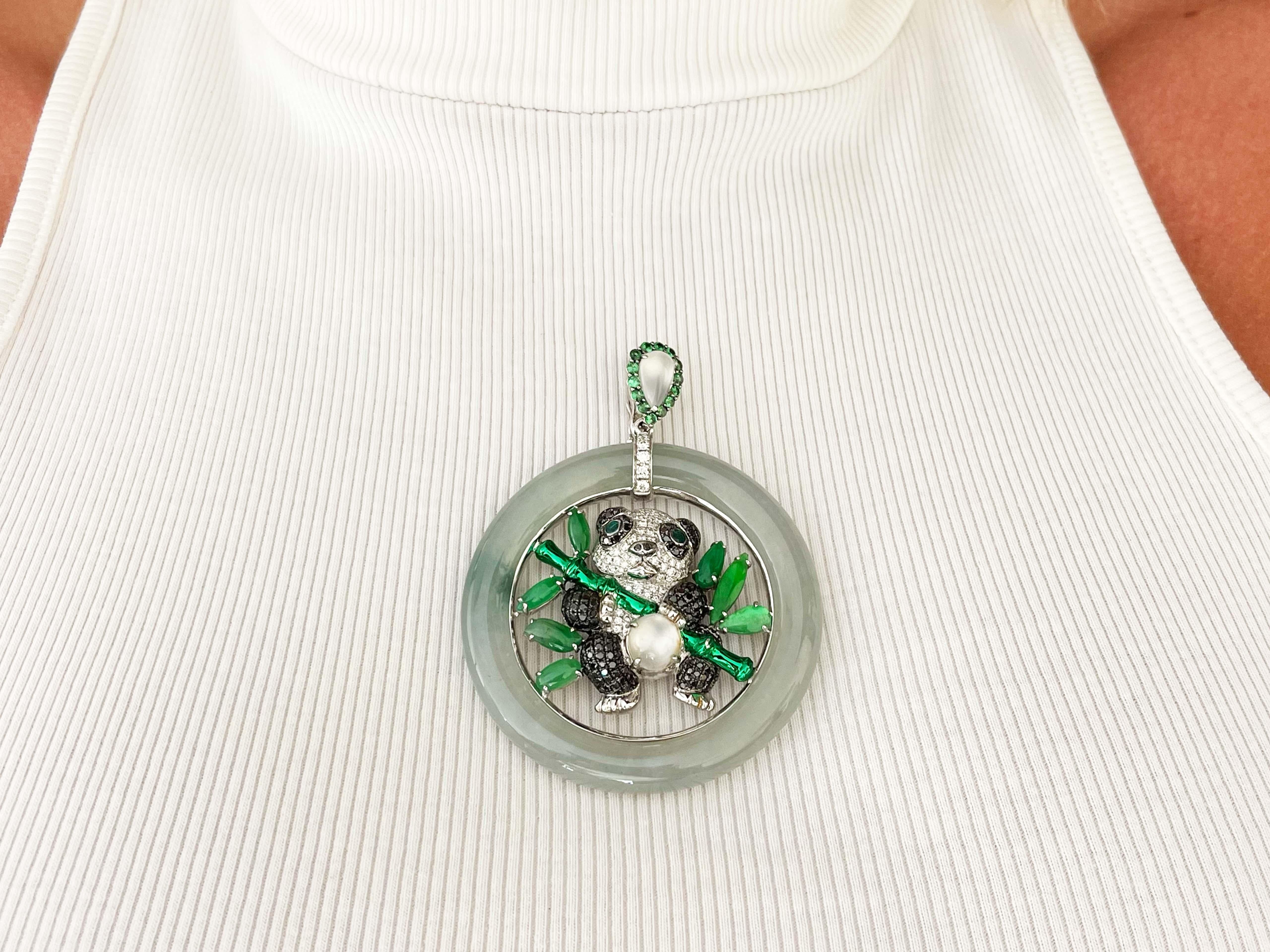 This unique one-of-a-kind pendant features 1.51 carats of black diamonds and 0.78 carats of white diamonds. There is a total of 24.70 carats of jade and the panda eyes are made with 0.15 carats of green emeralds. There are 2 moonstones totaling 2.5
