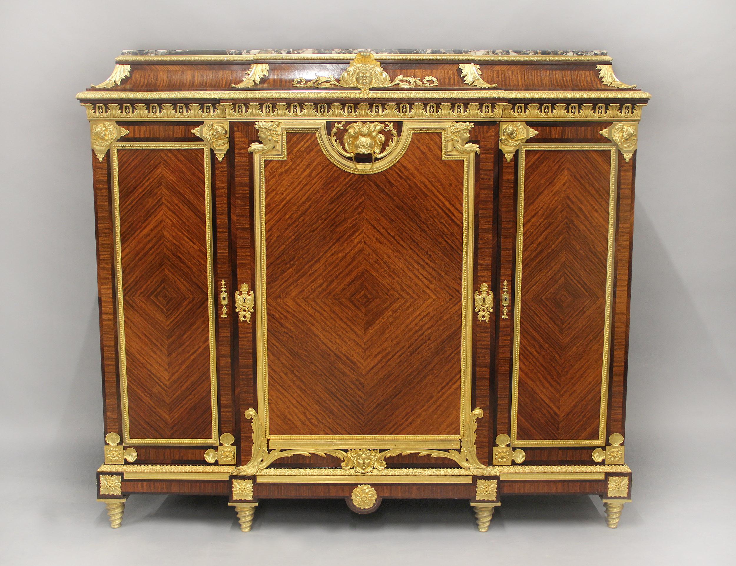 A Unique and Palatial Late 19th Century Gilt Bronze Mounted Louis XIV Style Cabinet By François Linke

François Linke – Index Number 490

The rare Baixas Breccia marble top above a bronze frieze, centered with a large mask of Minerva with scrolling