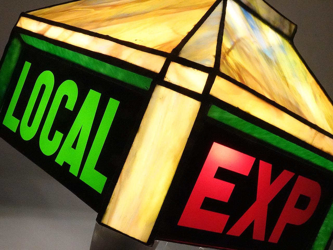 This stained glass table lamp is really unique. This will be something of interest to railroad enthusiasts. The 4 sided lamp reads EXP and LOCAL in red and green letters. On its own the lamp is striking and uses beautiful multi colored glass but the