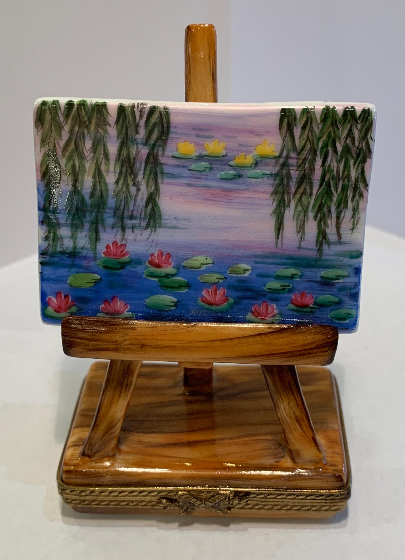 Collectible, limited edition Limoges porcelain miniature trinket box is handmade and hand painted and depicts a Claude Monet waterlily (or “Nympheas” in French) painting on an artists’ easel, the base of which is a shallow box. Claude Monet (1840 –