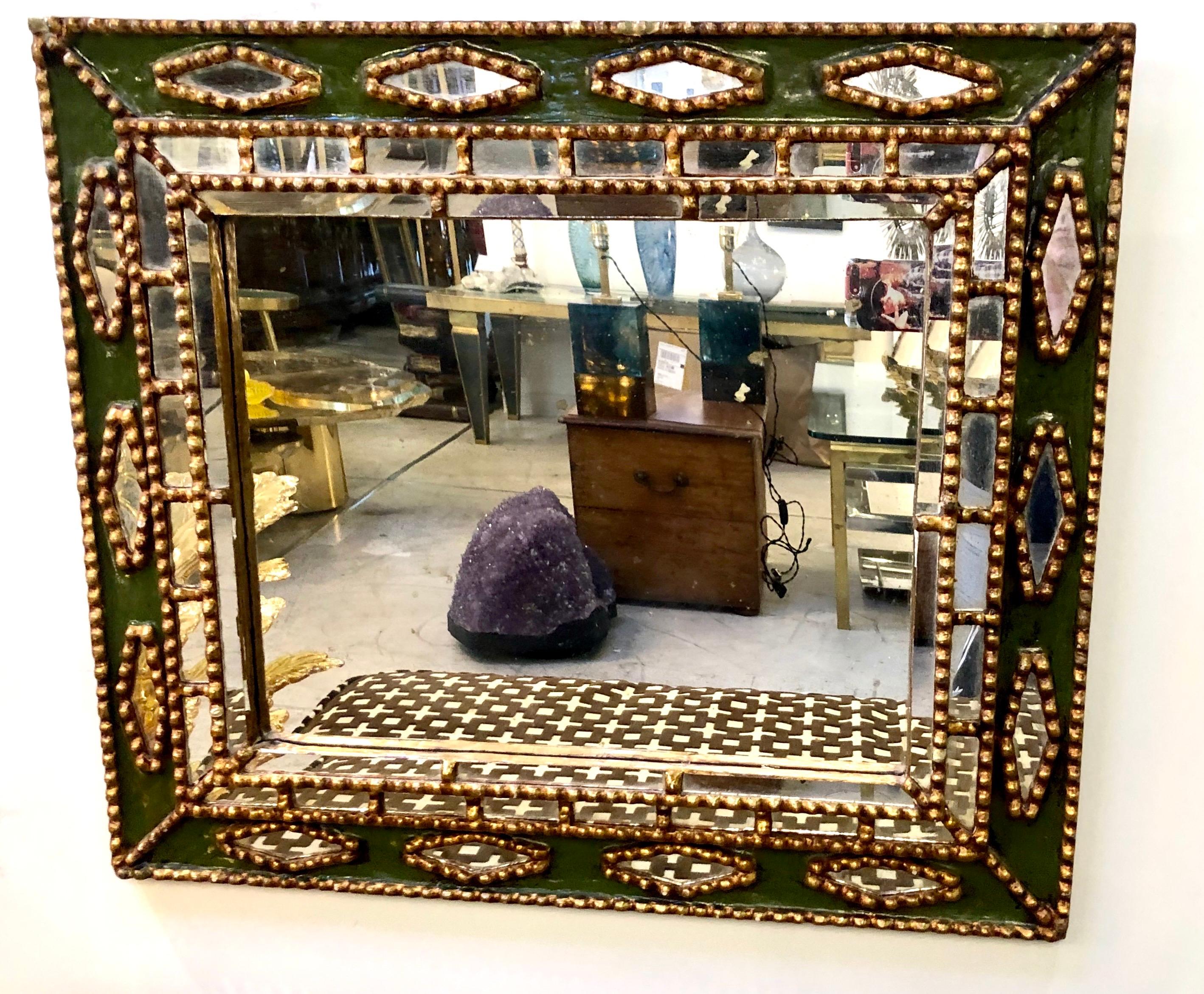 Gilt wood set on subtle green enamel form a unique mid century mirror in the style of Line Vautrin.