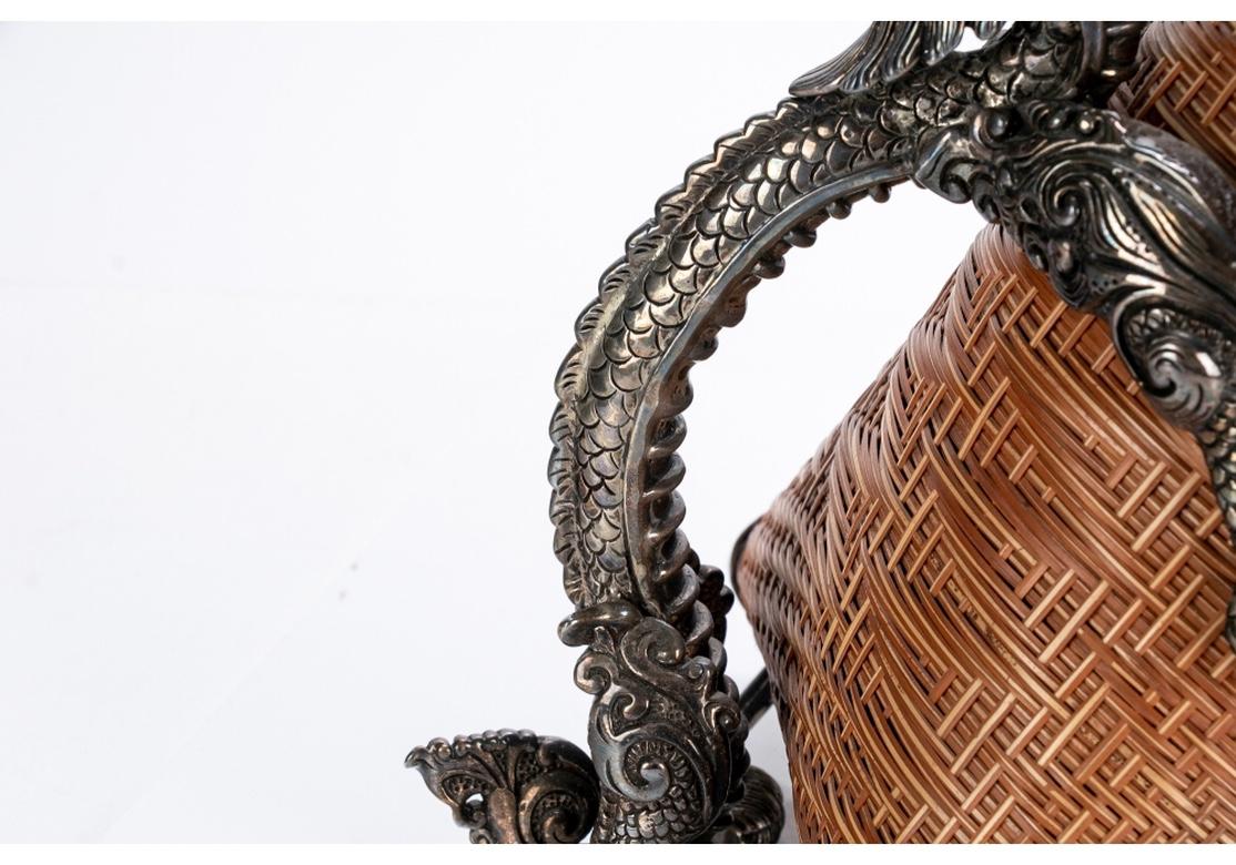Exquisite and much sought after Dragon basket wine server from Lotus Arts de Vivre, the premier International purveyors of superlative objects, home decor and jewellery. Mounted on a horizontal sterling silver stand with attached Dragon form handle