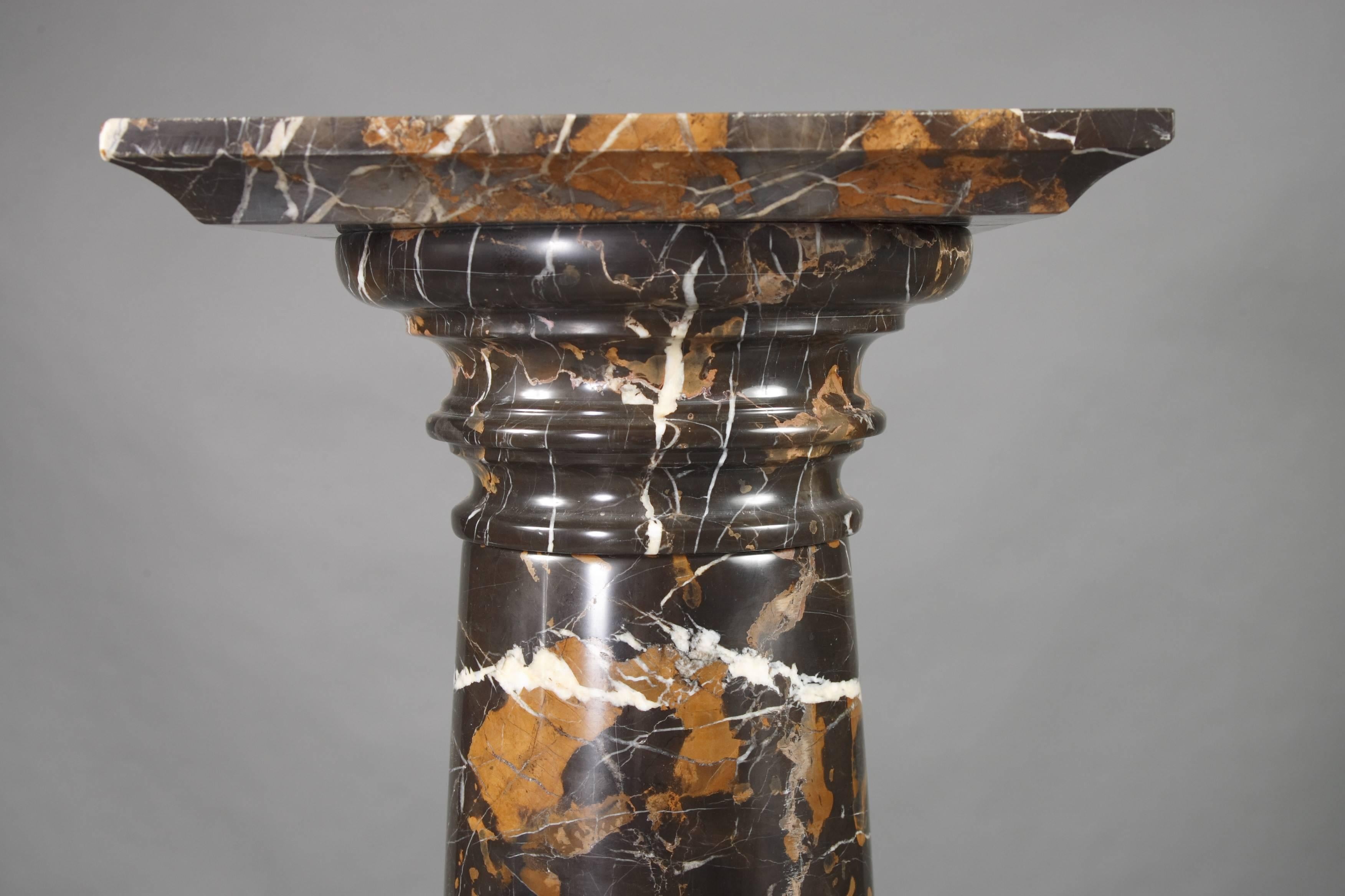 Black marble with grey-white grain. Stepped round foot in distended shank. Ovoider body, slightly rising neck and broad arched edge.
This column can be divided in five pieces.

Very heavy more than 80kg.