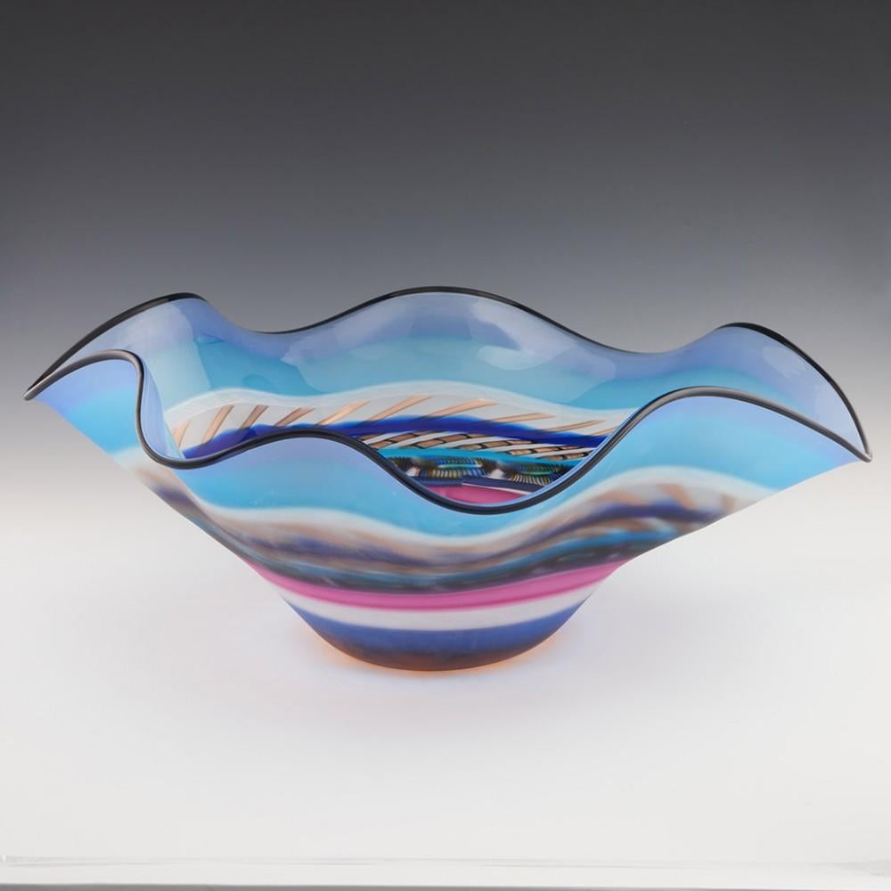 Heading : Unique massive Gianluca Vidal Murano glass sculptural bowl
Date : 2000-2010
Origin : Murano, Italy
Bowl Features : Black banded contoured rim. Polychrome banded body with royal blue, turquoise, magenta, and rose pink. There are two bands
