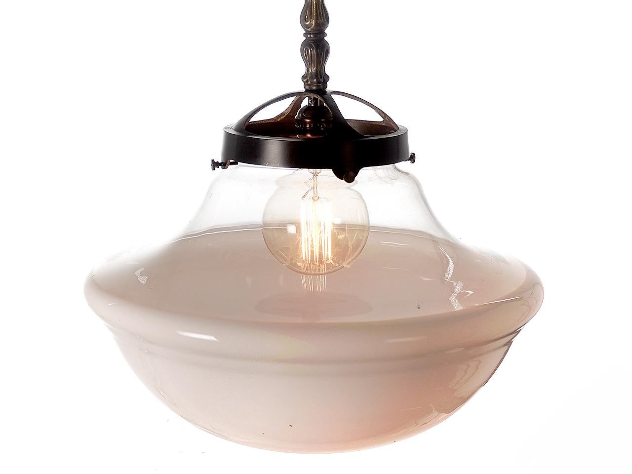 These lamps are sold as a matching pair. One price for the set. Early schoolhouse pendents have always been popular. This example is unique because the top half is clear glass giving them a different look. The bottom half is milk glass and it almost