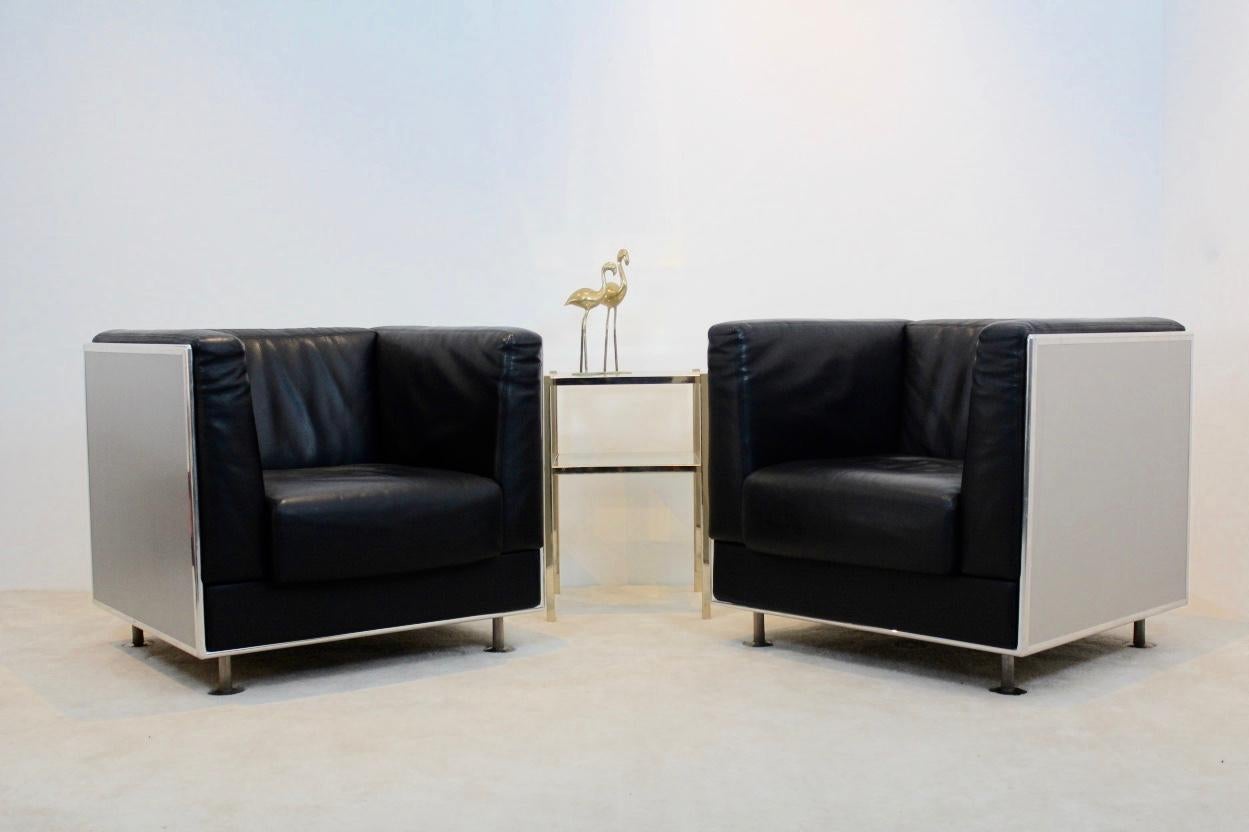 Set of unique two Italian black leather armchairs with an aluminium shell. Designed by Kunihide Oshinomi and manufactured by Matteo Grassi. These lounge chairs are extremely comfortable to sit in. The set has a very solid polished and anodized