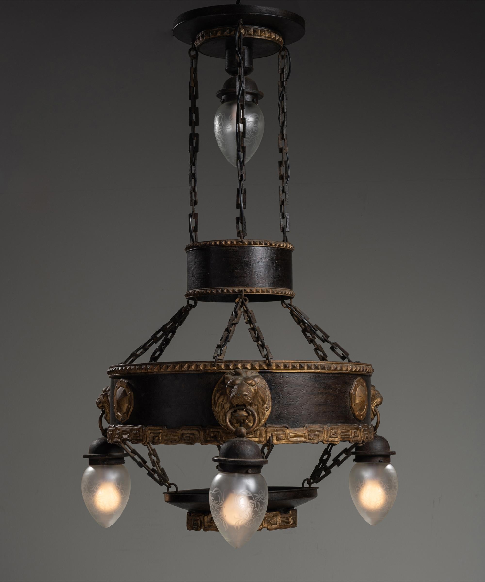 Unique metal chandelier, France, circa 1920

Iron chandelier with gilt framework, and lions heads holding etched glass pendants.

Measures: 29.5