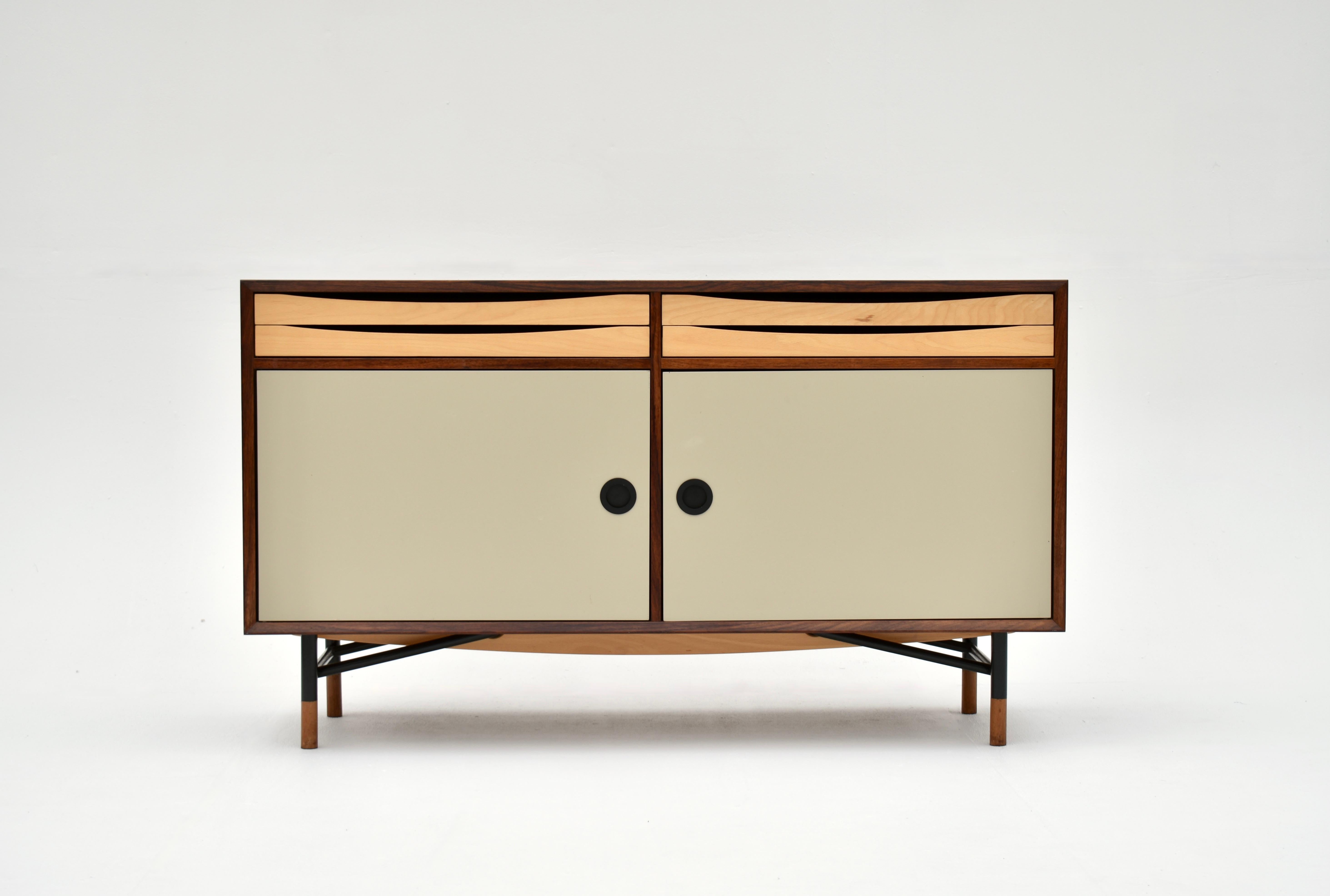 A very handsome high quality sideboard very much in the style of Finn Juhl.

Drawing very heavily upon the designs of Juhl and Vodder the sideboard features a Rosewood carcass with Taupe coloured enamel doors. Above the doors four slim drawers of