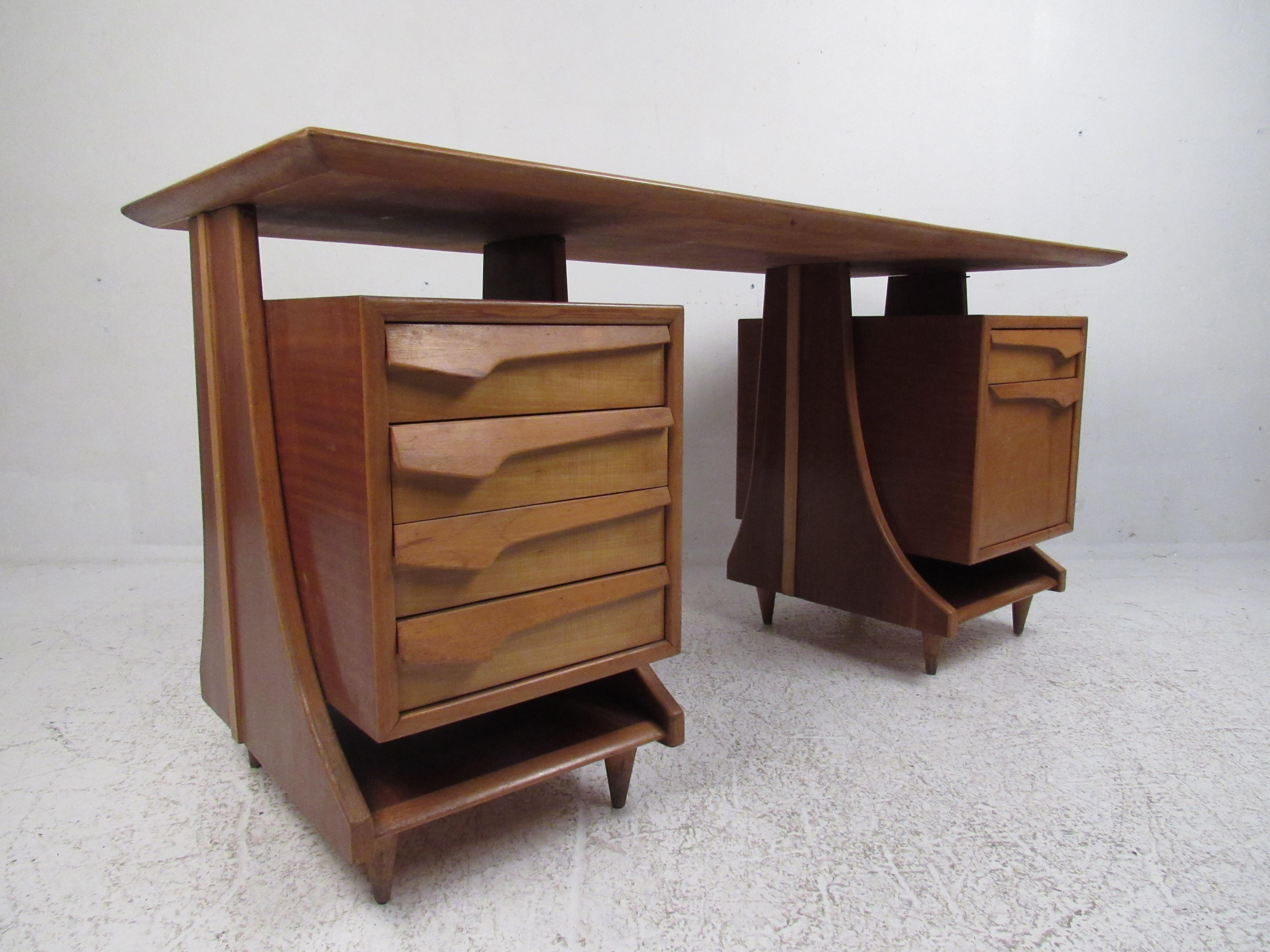 This beautiful vintage modern Italian desk features a floating top, sculpted drawer pulls, and arched sides. A well-made case piece with a large curved drawer that opens sideways offering ample room for files. The large tabletop and spacious drawers